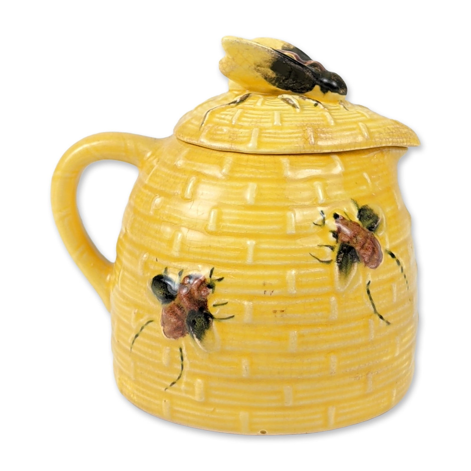Yellow Glazed Beehive Ceramic Honey Pot with Lid: Mid-20th century style ceramic honey pot in a beehive form, featuring a molded basketweave texture and a yellow glaze. The pot is decorated with three applied hand-painted bees, with a larger figural 