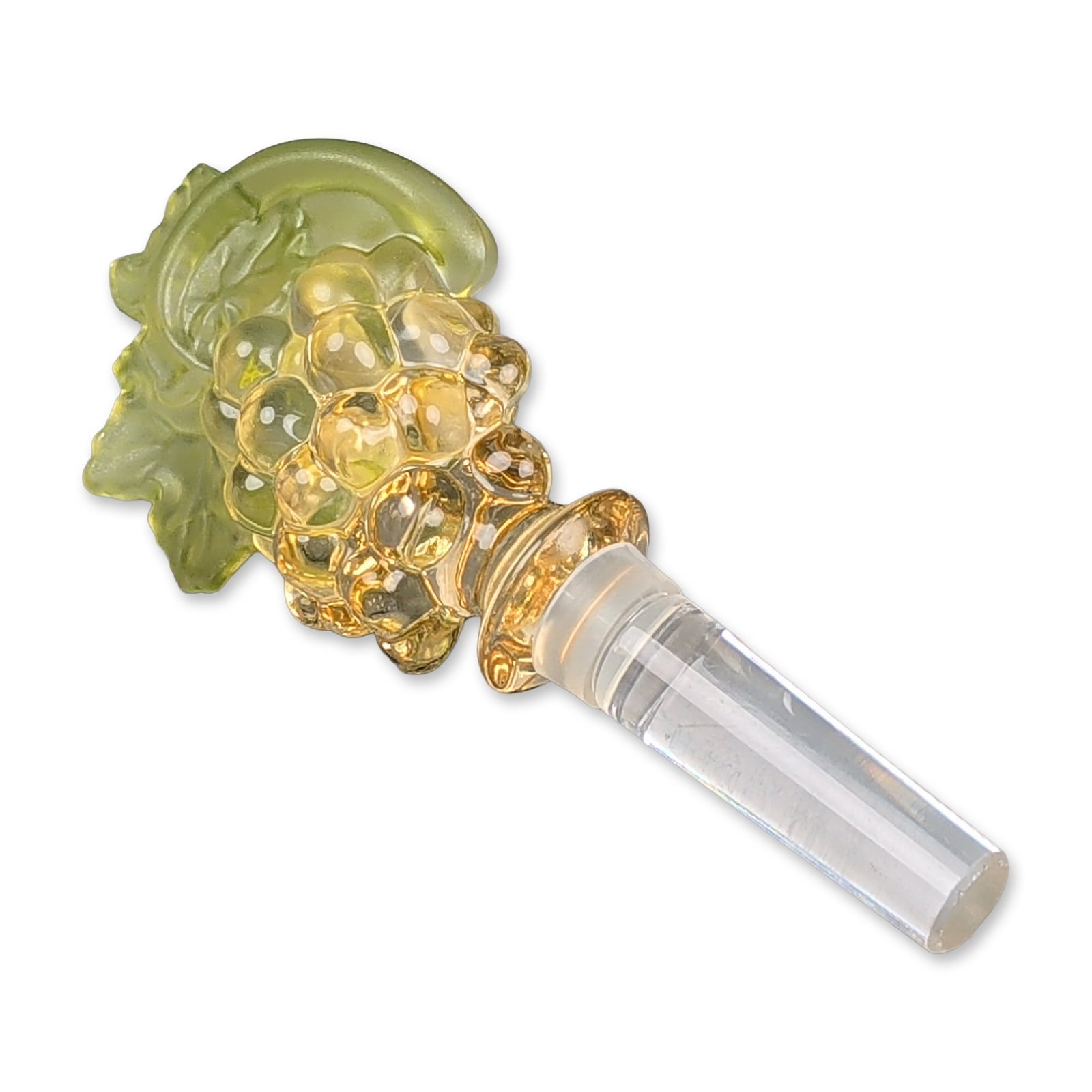 Mikasa Crystal Chablis Grape Cluster Wine Bottle Stopper: Naturalistic crystal bottle stopper featuring a hand-formed cluster of translucent amber-toned grapes and a single frosted green glass vine leaf with molded vein details. The decorative element is fus