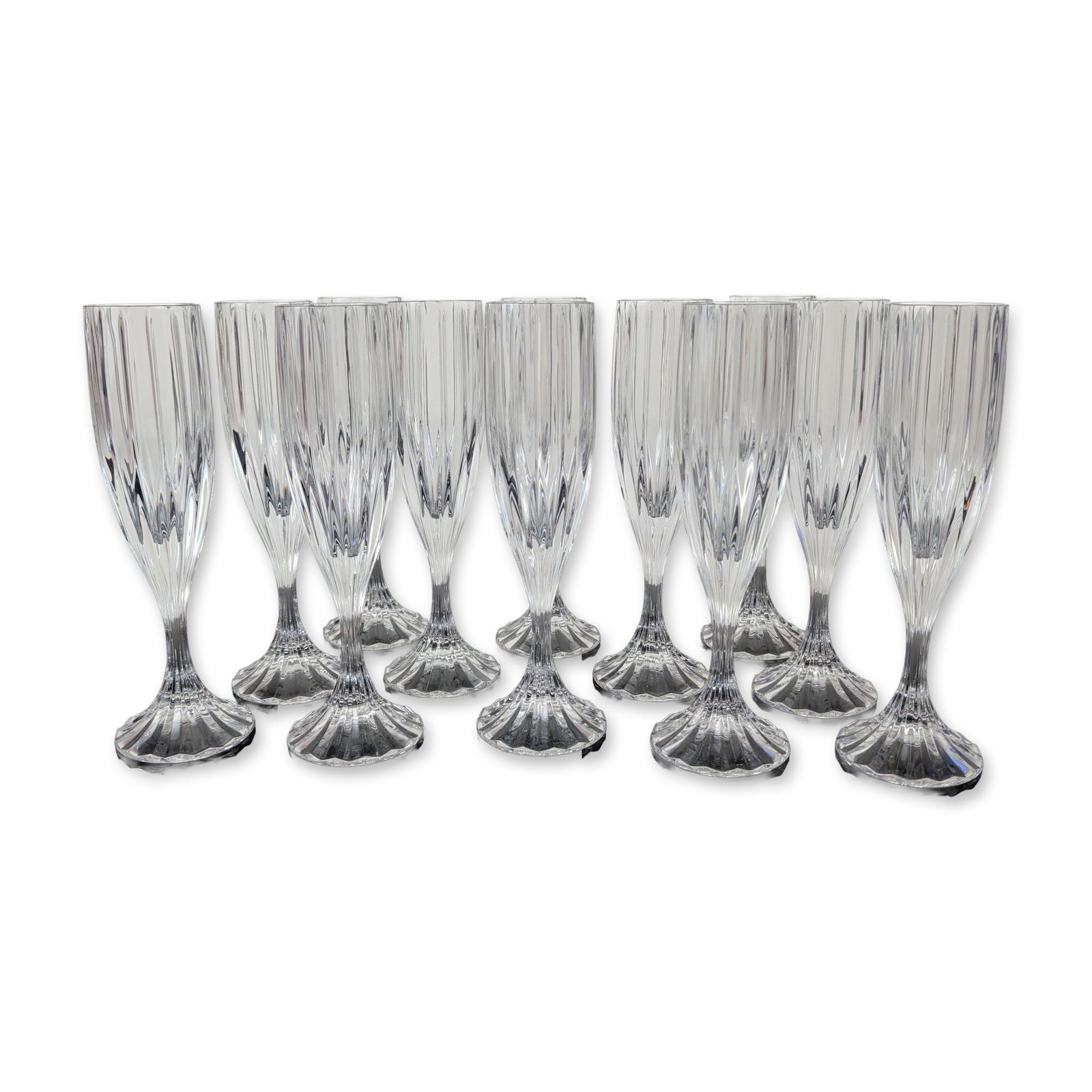 12pc Mikasa Park Lane Crystal Champagne Flutes: Set of twelve champagne flutes from Mikasa in clear lead crystal in the Park Lane pattern. Each piece features deep vertical panel cuts to the bowl, a short multi-faceted stem, and a circular foot wit