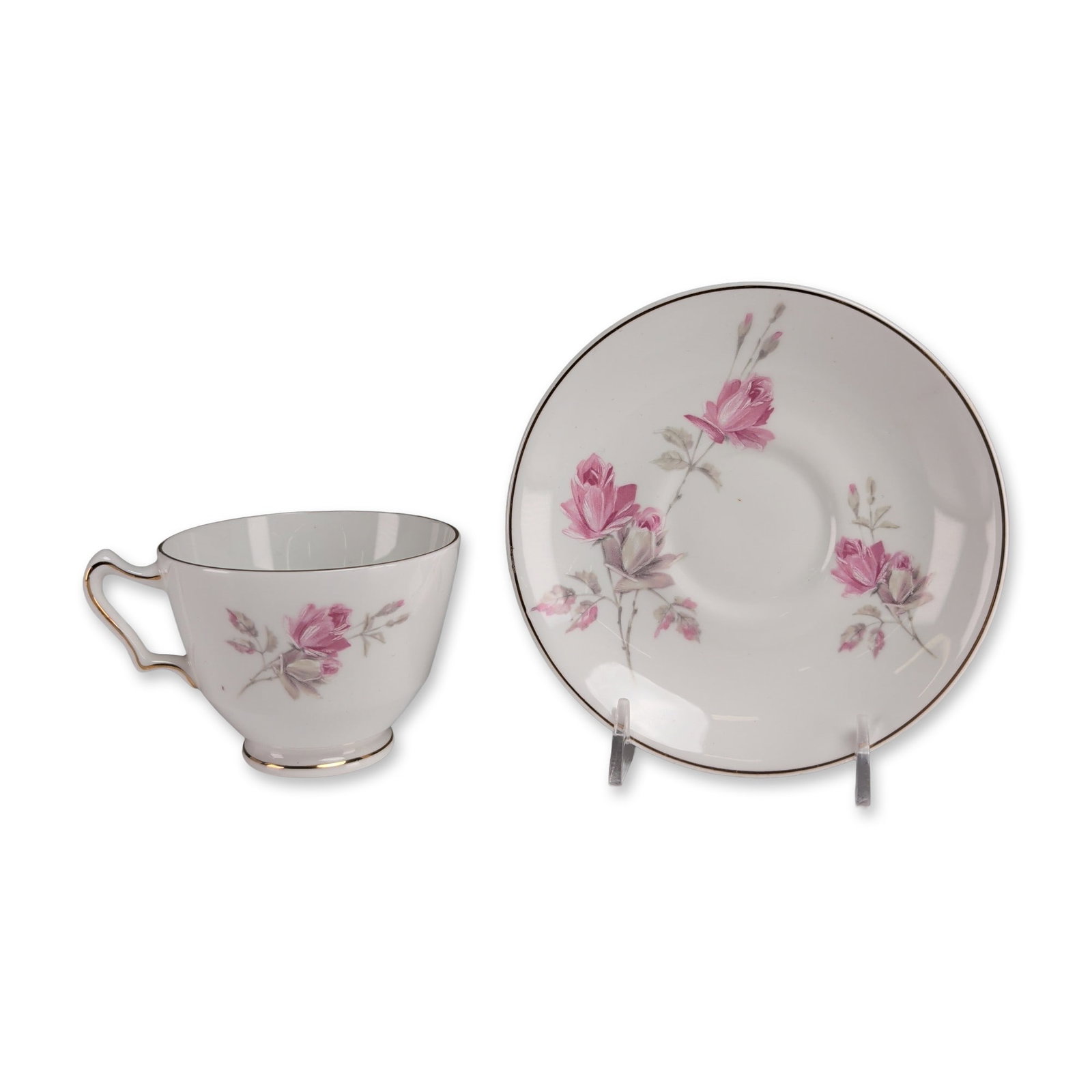 2pc Crown Staffordshire Bone China Cup and Saucer: Crown Staffordshire teacup and saucer set in fine bone china, featuring transfer-printed pink rose floral sprays with gray-green leaves. The footed teacup includes a scrolled handle and everted rim, b