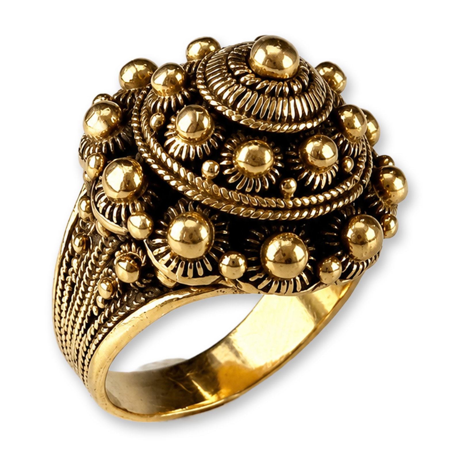 18 Karat Gold Etruscan Ring: 18 karat yellow gold domed cocktail ring featuring a tiered bombe design with intricate granulation and filigree work. The central peak features a polished sphere set upon a sunburst-patterned disc wi