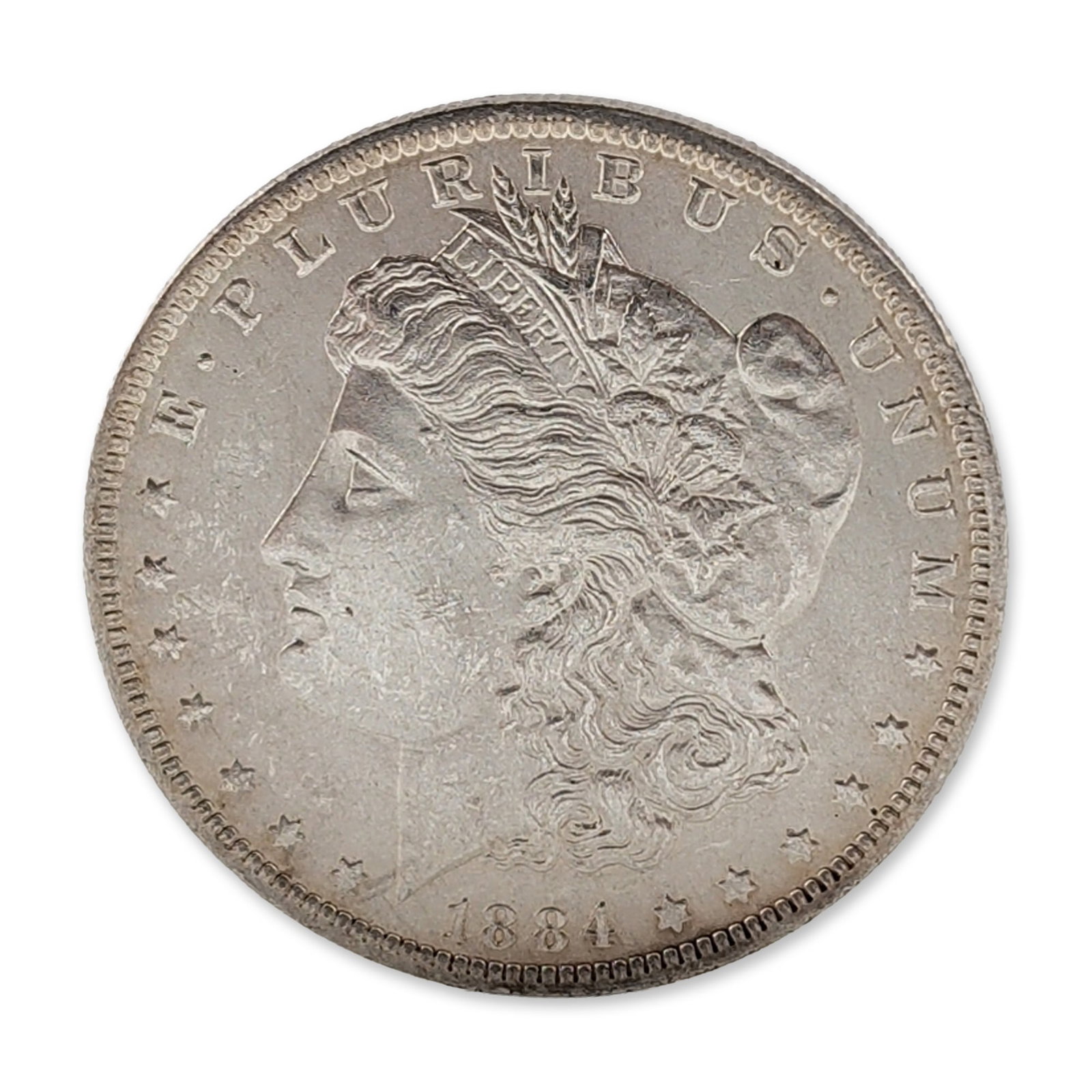 1884-O US Morgan Silver Dollar Coin: 1884-O US Morgan silver dollar, New Orleans mint. Struck in 90% silver and 10% copper with a reeded edge. Obverse features the Liberty Head design type. Reverse features the Eagle design type. The obv