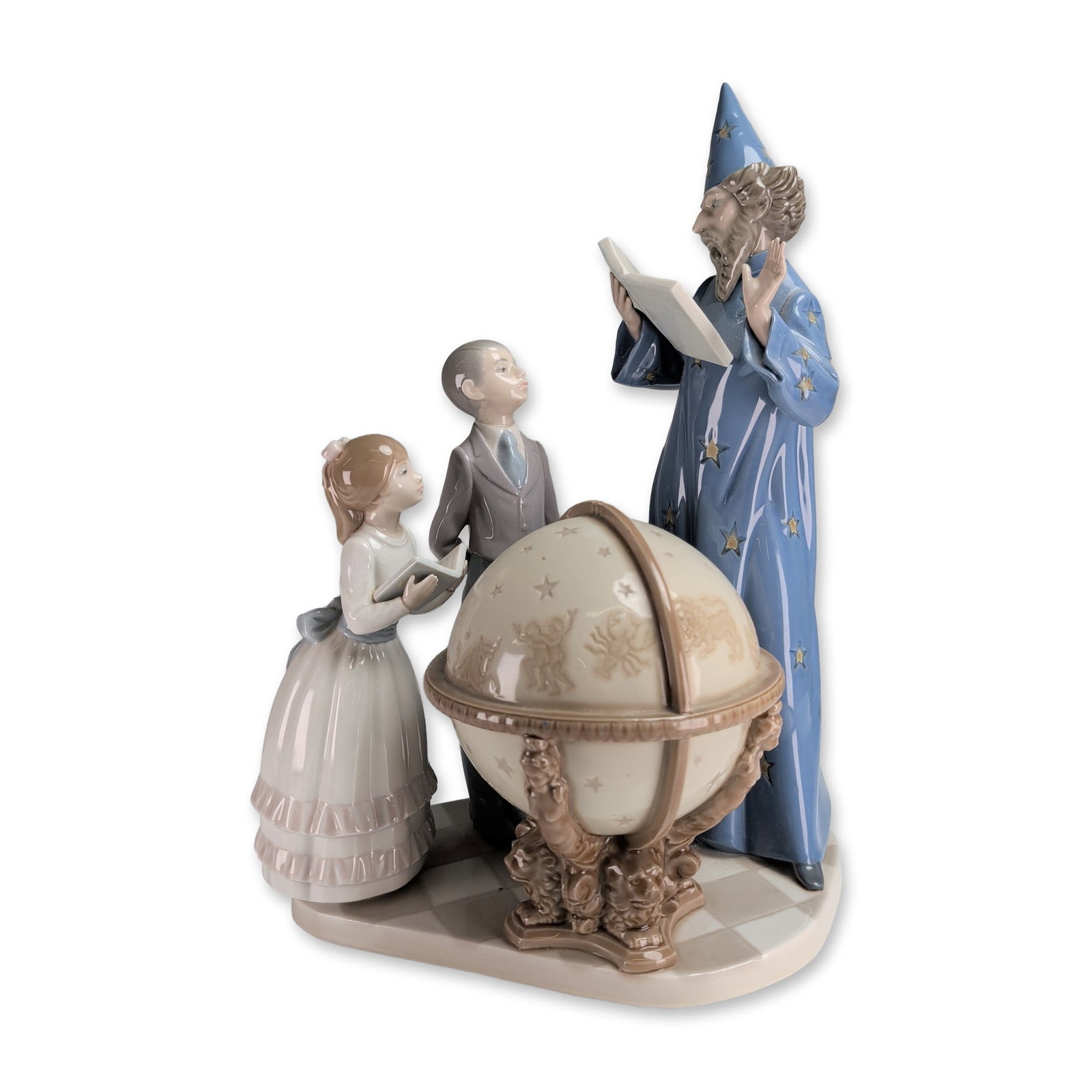 Lladro Glossy Porcelain Sculpture, Astronomy Lesson 1001355: Designed by Francisco Catala. The composition depicts a wizard in a floor-length blue robe decorated with golden stars and a matching pointed hat, holding an open book and gesturing toward a large cel