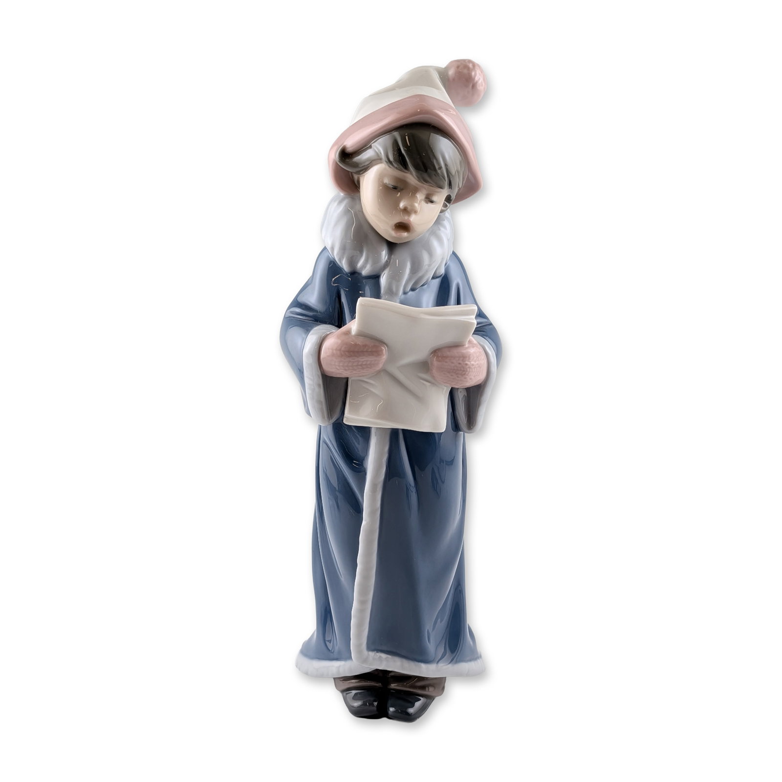 Lladro Porcelain Christmas Caroler Figurine: Lladro (Valencia, Spain). Glazed porcelain figurine titled The Christmas Caroler, number 6533, sculpted by Juan Huerta. The figure is depicted in winter attire featuring a blue coat with white trim, p
