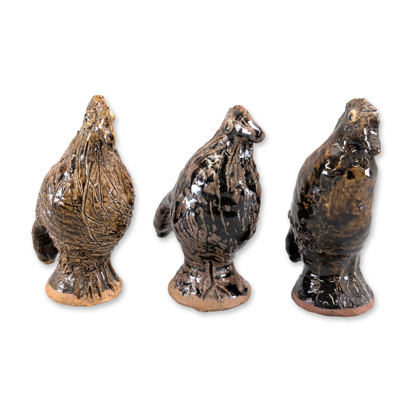 3pc Marie Rogers Pottery Georgia Folk Bird Figurines: A trio of hand-modeled studio ceramic bird figurines in varying glazes. Each stylized avian form is set on an integral circular pedestal base. The collection showcases three distinct surface
