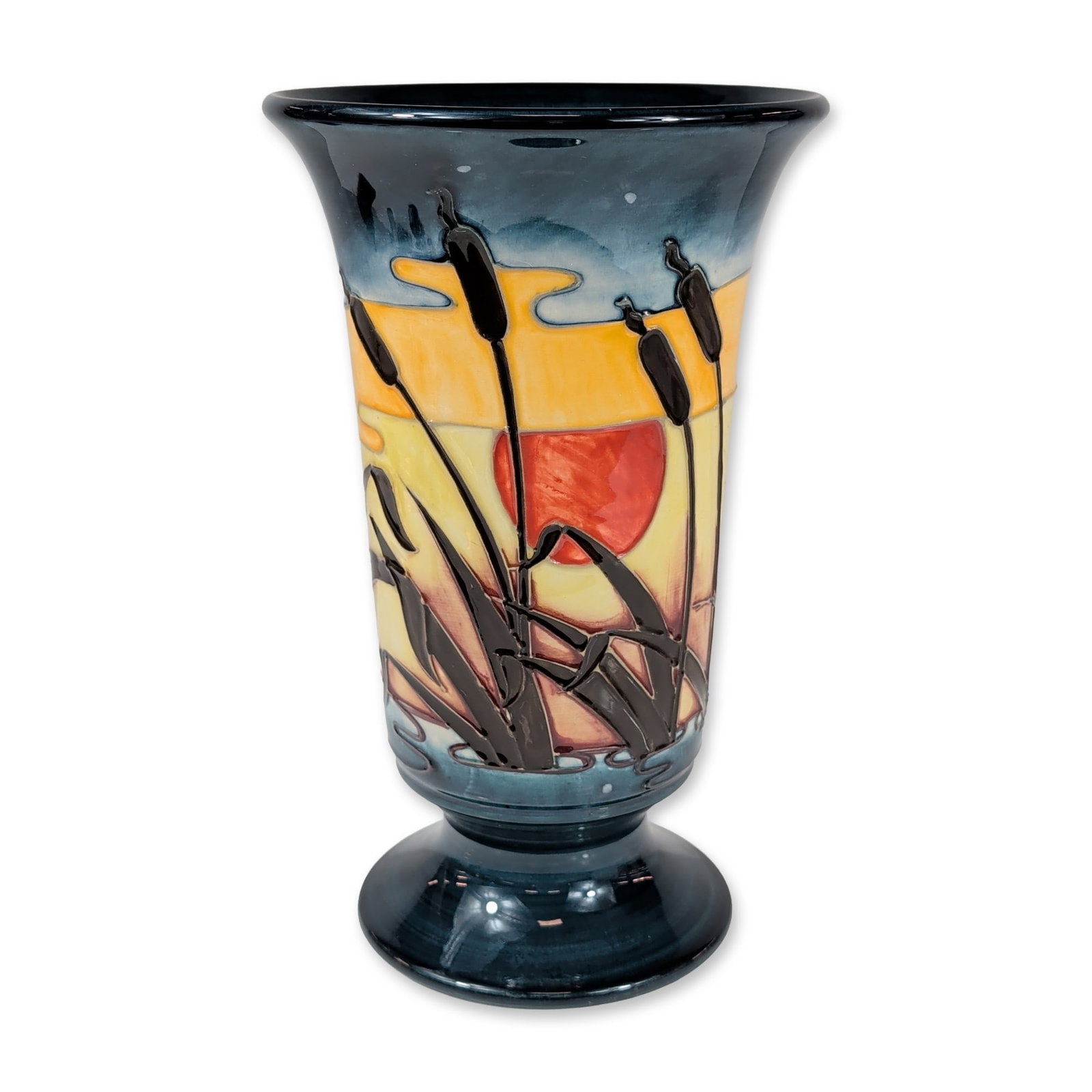 Moorcroft Reeds at Sunset Bullrushes Pottery Vase: Moorcroft Pottery earthenware vase in a flared trumpet form with a circular pedestal base. The piece is decorated in the Reeds at Sunset pattern, featuring a tubelined landscape of bulrushes set