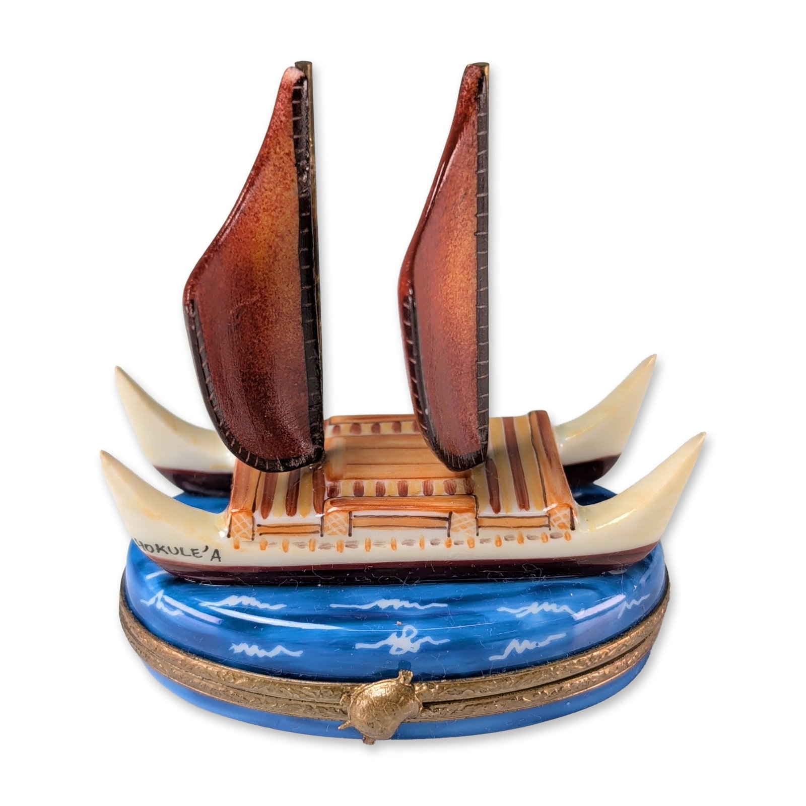 Limoges Peint Main Hokulea Canoe Trinket Box: Limoges, France. Peint main porcelain hinged trinket box modeled as the Polynesian voyaging canoe Hokulea, featuring double hulls, four white curved prows, and two reddish-brown sails set upon an oval