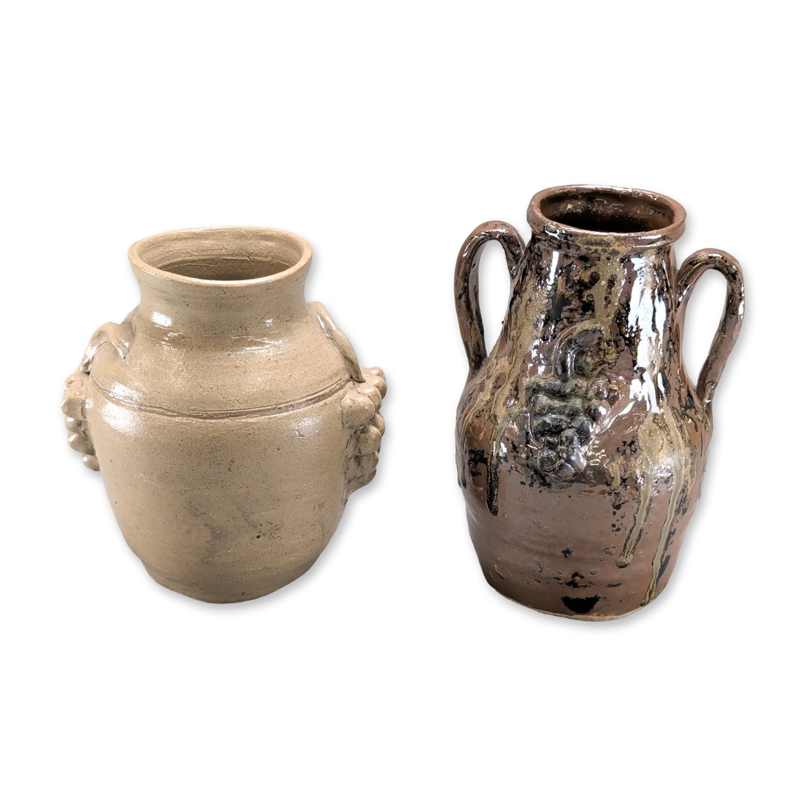 2pc Marie Rogers Georgia Folk Pottery Stoneware Jars: Marie Rogers (American, 1922-2010), two Southern folk pottery stoneware jars featuring applied grape cluster motifs. The first vessel is a buff-colored ovoid jar with a clear glaze, applied grape clus