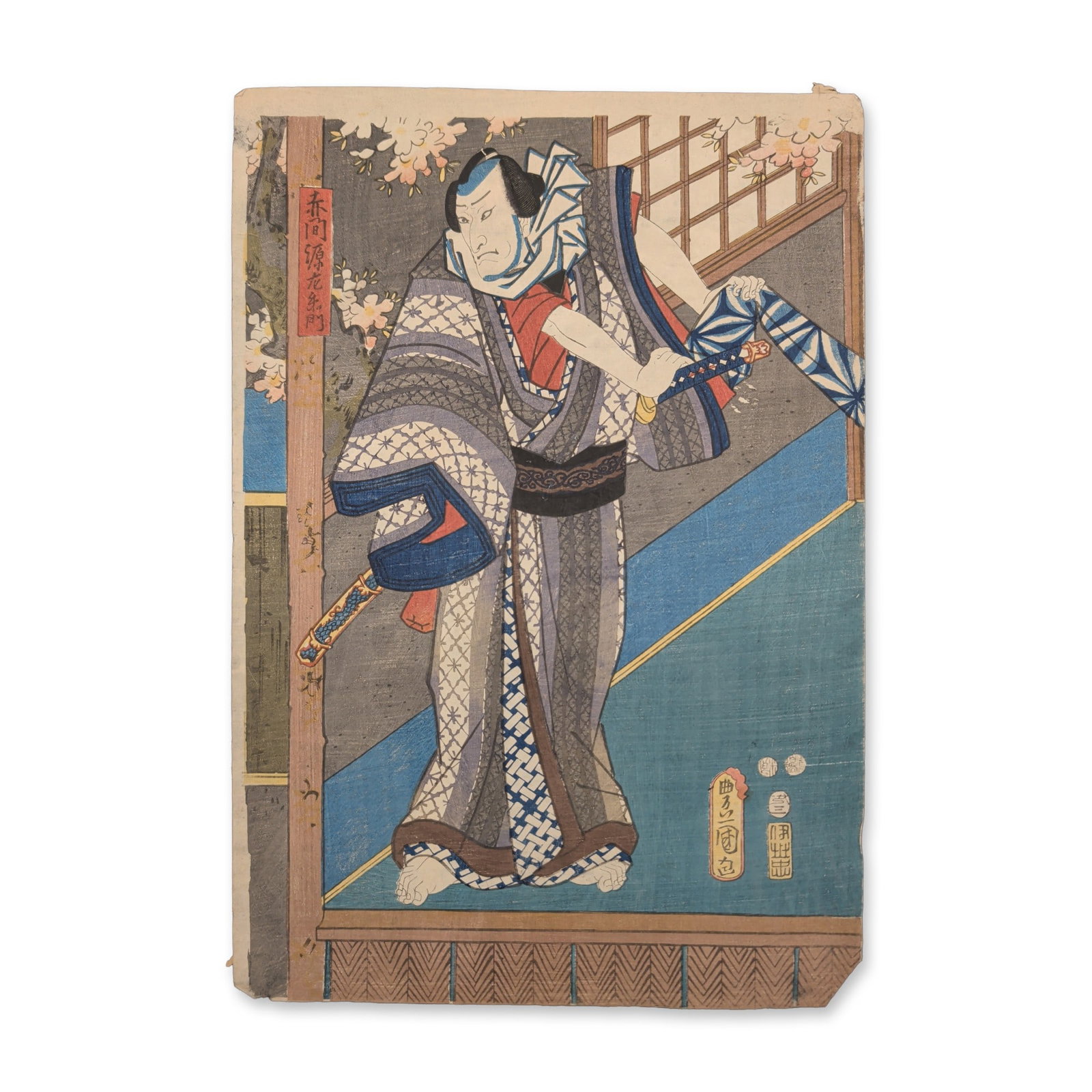 Utagawa Kunisada (Toyokuni III) (Japanese, 1786-1865) Kabuki Actor on a Veranda Woodcut: A Kabuki actor stands on an architectural veranda with a geometric lattice balcony fence, gripping a partially unsheathed katana sword while looking over one shoulder. This ukiyo-e design depicts the 