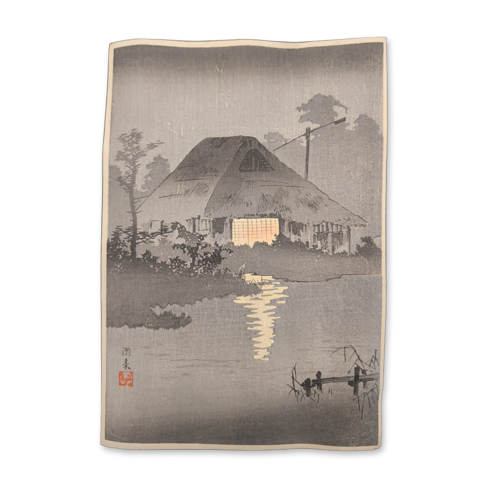 Takahashi Shotei (Japanese, 1871-1945), Woodcut on Paper, Itako: Takahashi Shotei (Hiroaki) Japanese woodblock print titled Itako, depicting a nocturnal landscape with a traditional thatched-roof minka house. The composition features a lit lattice window with a war