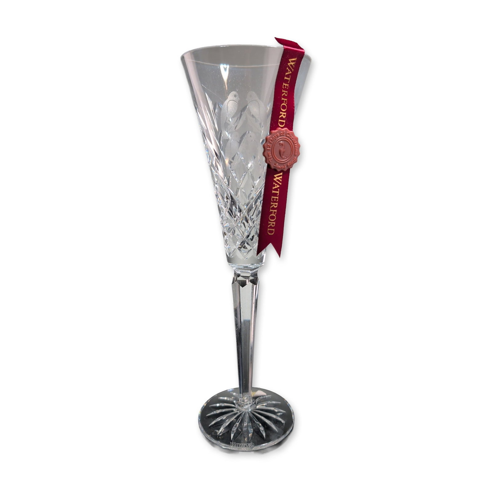 Waterford Crystal 12 Days of Christmas Fluted Champagne, Four Calling Birds: The tapered conical bowl features deep criss-cross diamond cuts on the lower half and an acid-etched depiction of four birds within a holiday holly wreath. A multi-faceted hexagonal stem joins the