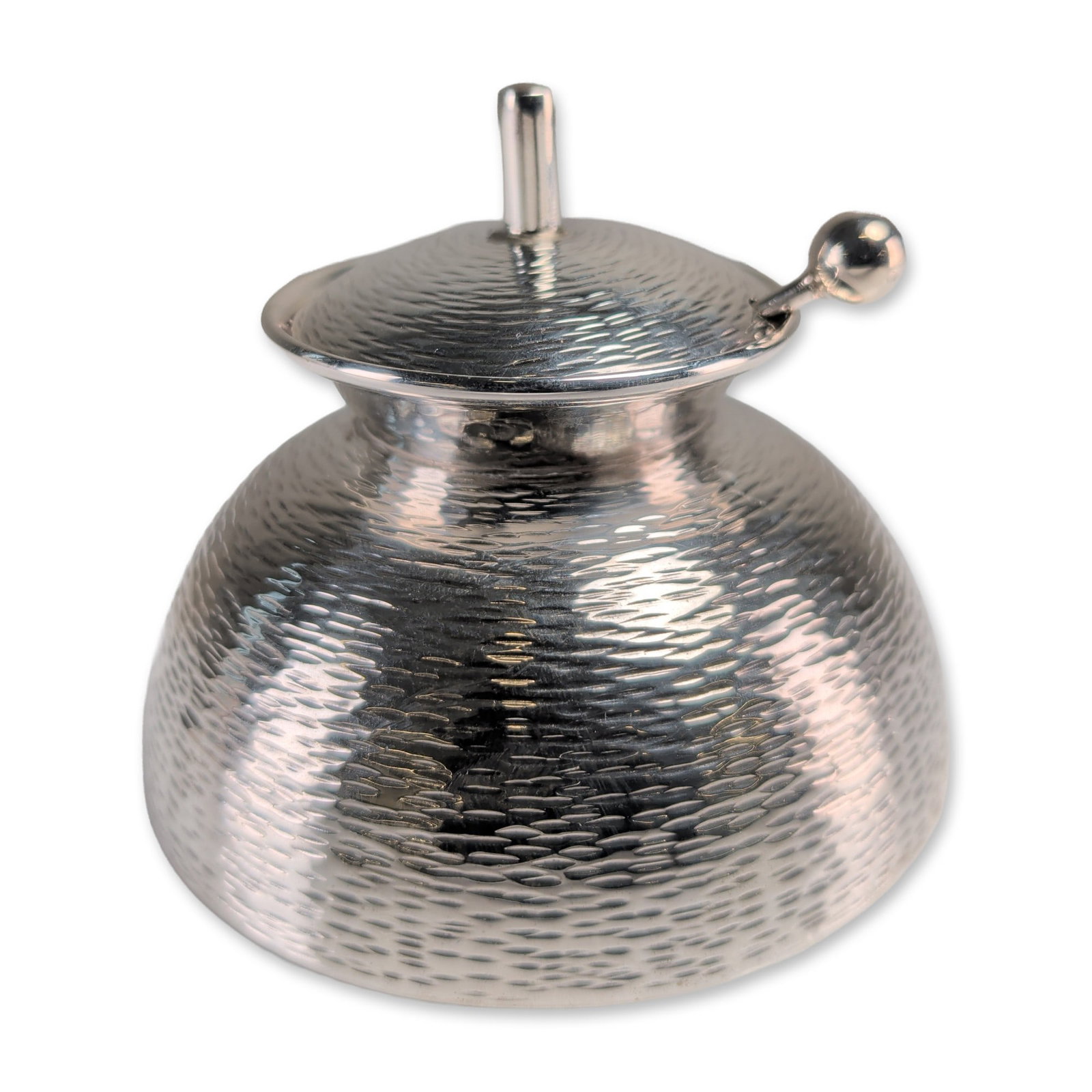 Modernist Solid Silver Martele Lidded Sugar Bowl with Spoon: A Modernist solid silver hand-hammered textured lidded sugar bowl with a spoon. The vessel is of compressed globular form with a flared, polished interior rim and a conforming domed lid. The lid is