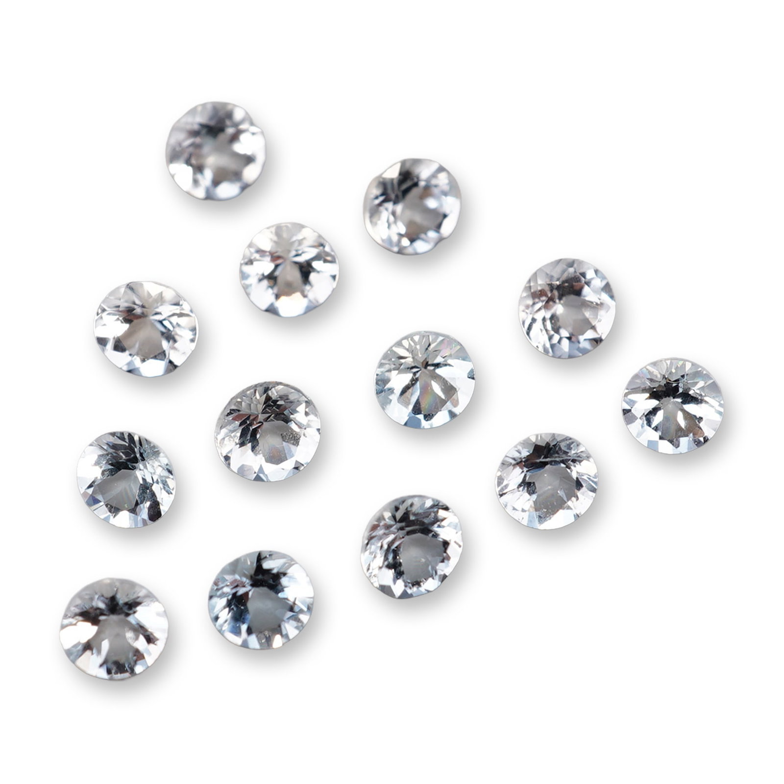 Collection of Loose Aquamarine Gemstones: A collection of faceted loose gemstones in aquamarine. Each gemstone is round brilliant cut, exhibiting an extremely pale blue to near-colorless hue with high transparency. The stones feature sharp