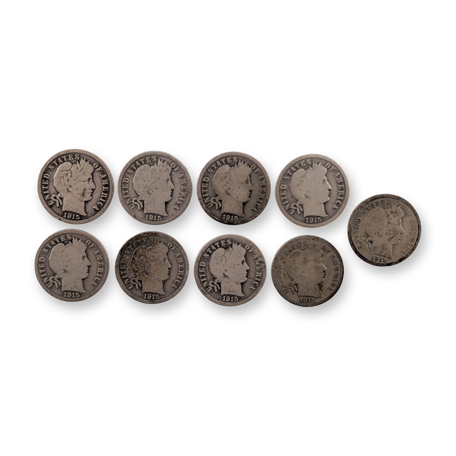 9pc 1915, 1915-S US Barber Silver Dime Coins: A group of nine United States 1915 Barber dimes struck in 90 percent silver. The obverse of each coin features the legend UNITED STATES OF AMERICA surrounding a profile of Liberty wearing a Phrygian c