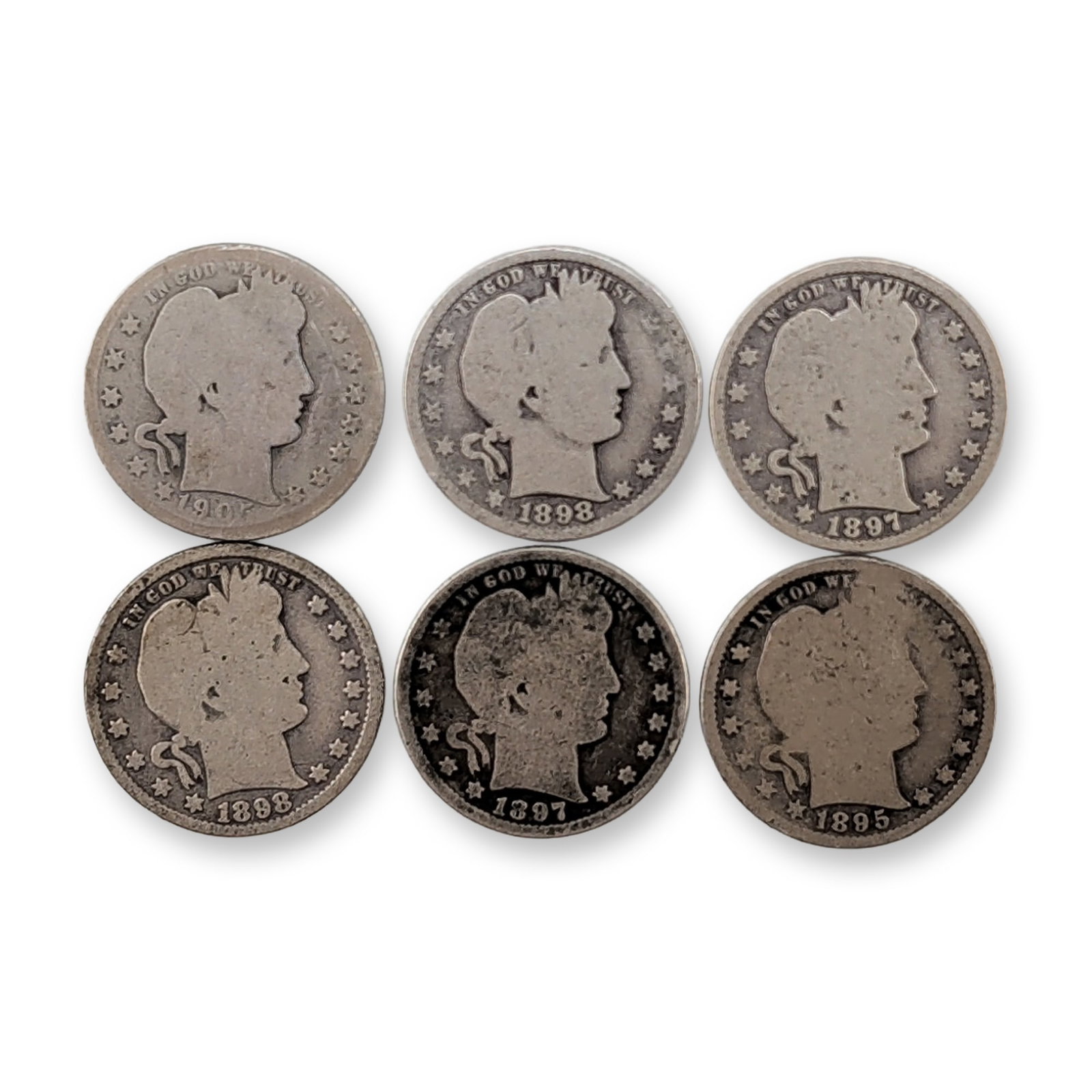 6pc 1895, 1897, 1898, 1905-O US Barber Silver Quarter Coins: A group of US Barber quarters struck in 90% silver, featuring the Liberty profile design by Charles E. Barber. The group includes coins dated 1895, 1897, 1898, and 1905. One specimen dated 1905 featur