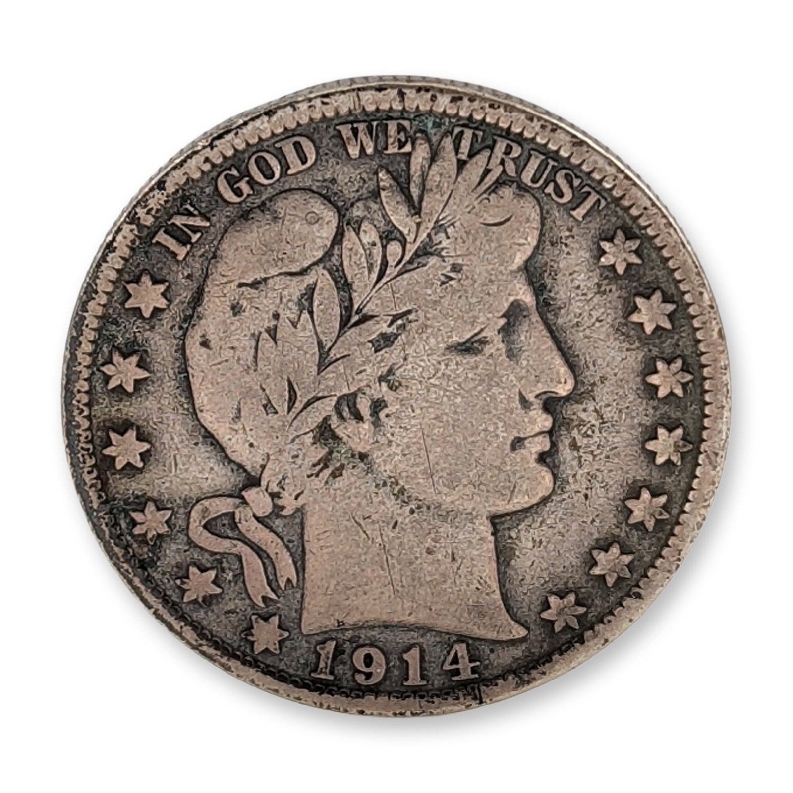 1914-S US Barber Silver Half Dollar Coin: 1914-S Barber half dollar. A US 90% silver coin produced at the San Francisco Mint. The obverse features a Liberty head facing right wearing a Phrygian cap and laurel wreath, inscribed IN GOD WE TRUST