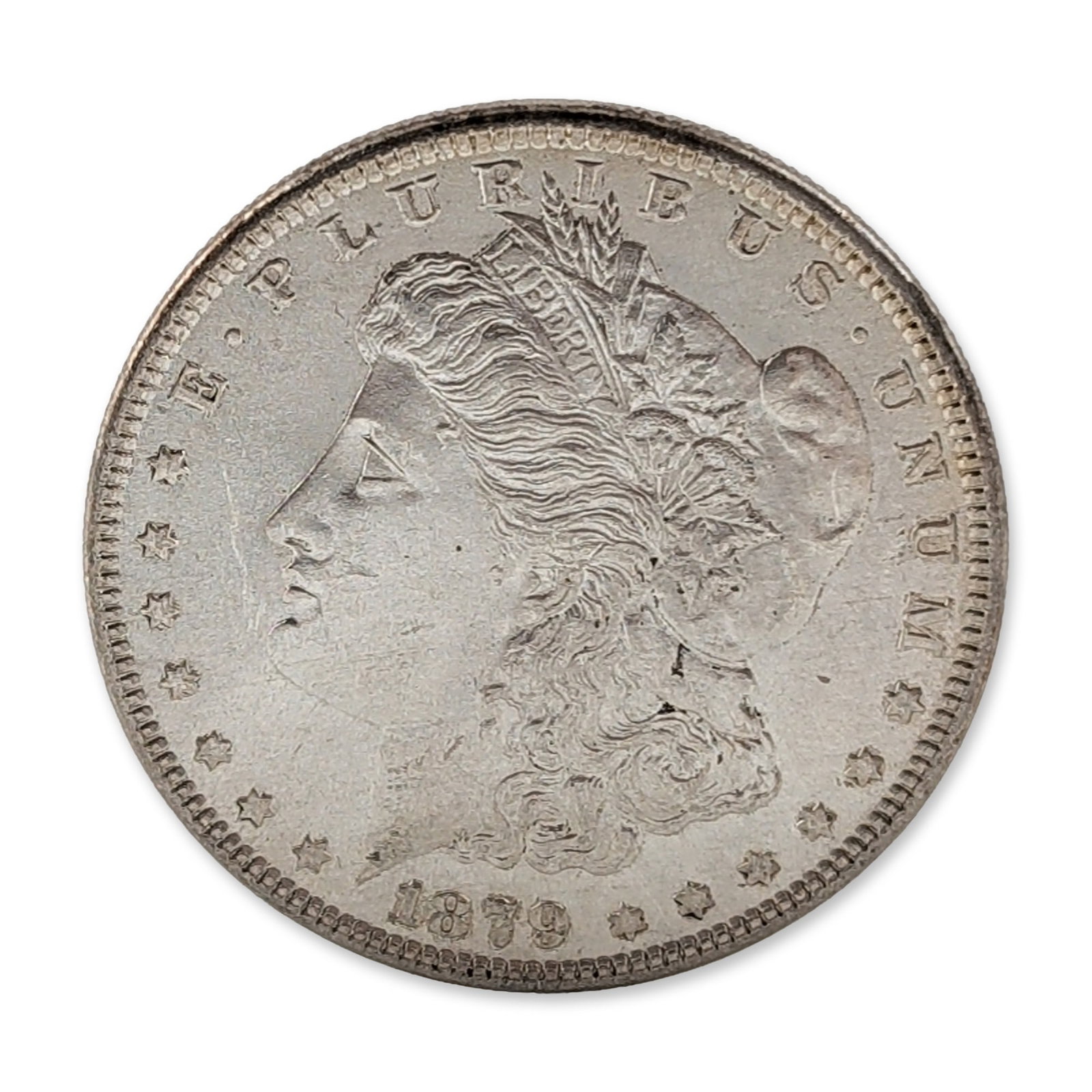 1879 US Morgan Silver Dollar Coin: US 1879 Morgan silver dollar composed of 90% silver and 10% copper. Philadelphia Mint issue, identified by the absence of a mint mark on the reverse. Design features the profile of Liberty on the obve