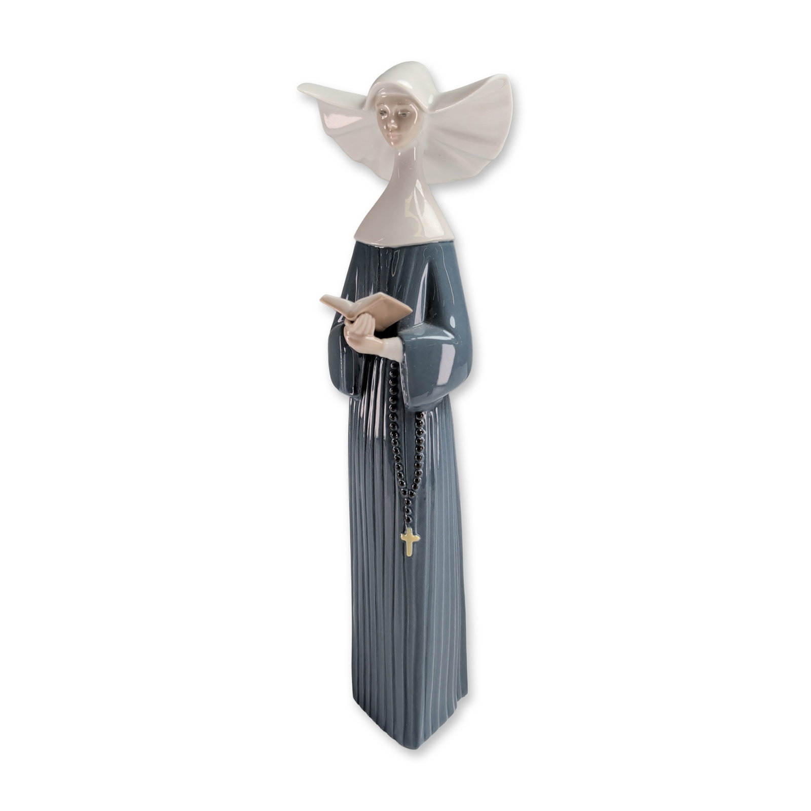 Lladro Glossy Porcelain Figurine, Prayerful Moment - Blue 1005500: The figure depicts a member of the Daughters of Charity in a blue-grey pleated habit and a white winged cornette headpiece. She is posed holding a tan prayer book with a black bead rosary and gold-ton