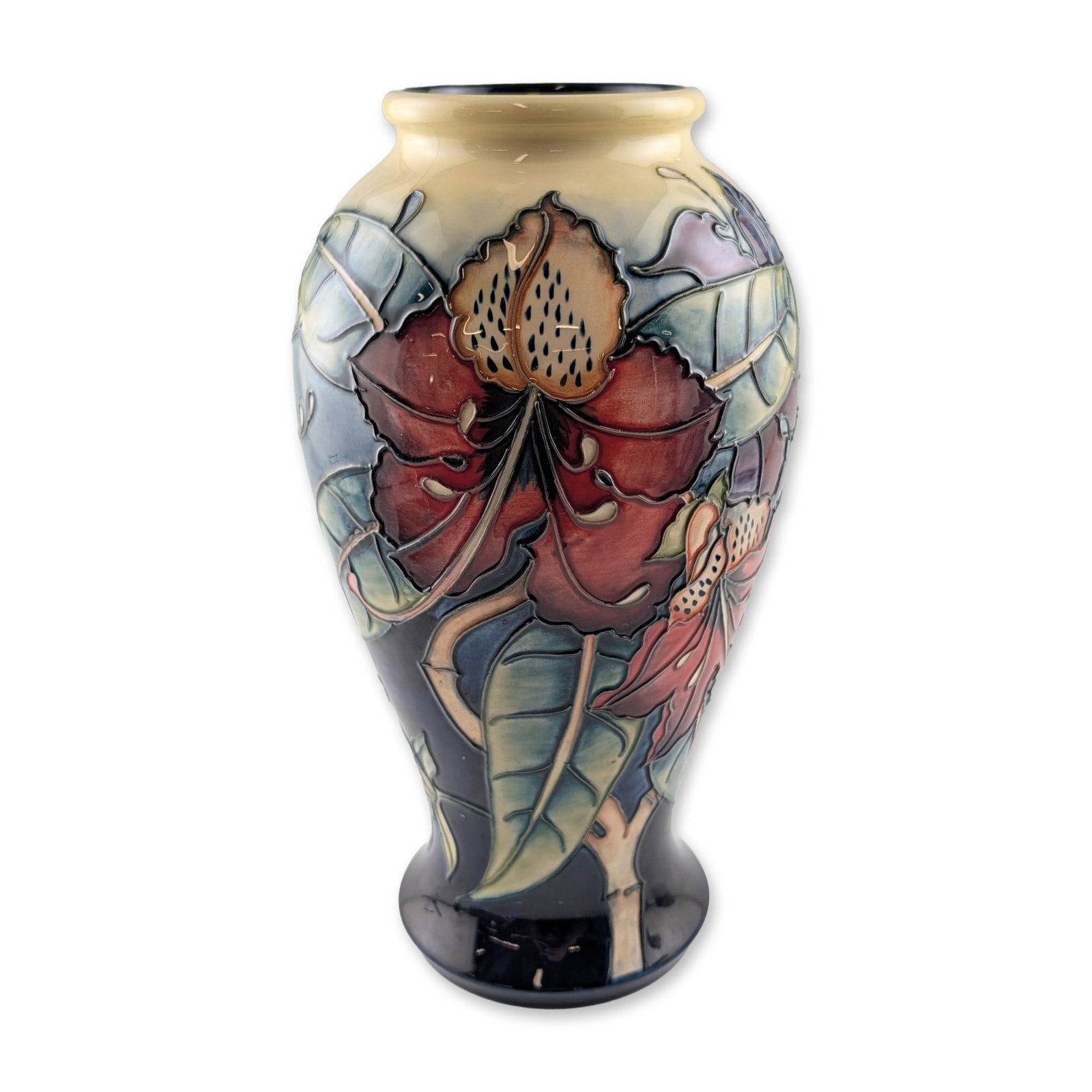 Moorcroft Philip Gibson Simeon Ceramic Vase: Moorcroft pottery vase in the Simeon pattern, designed by Philip Gibson circa 1999. This ceramic vessel features tube-lined floral motifs depicting lilies and foliage in shades of burgundy, sage green