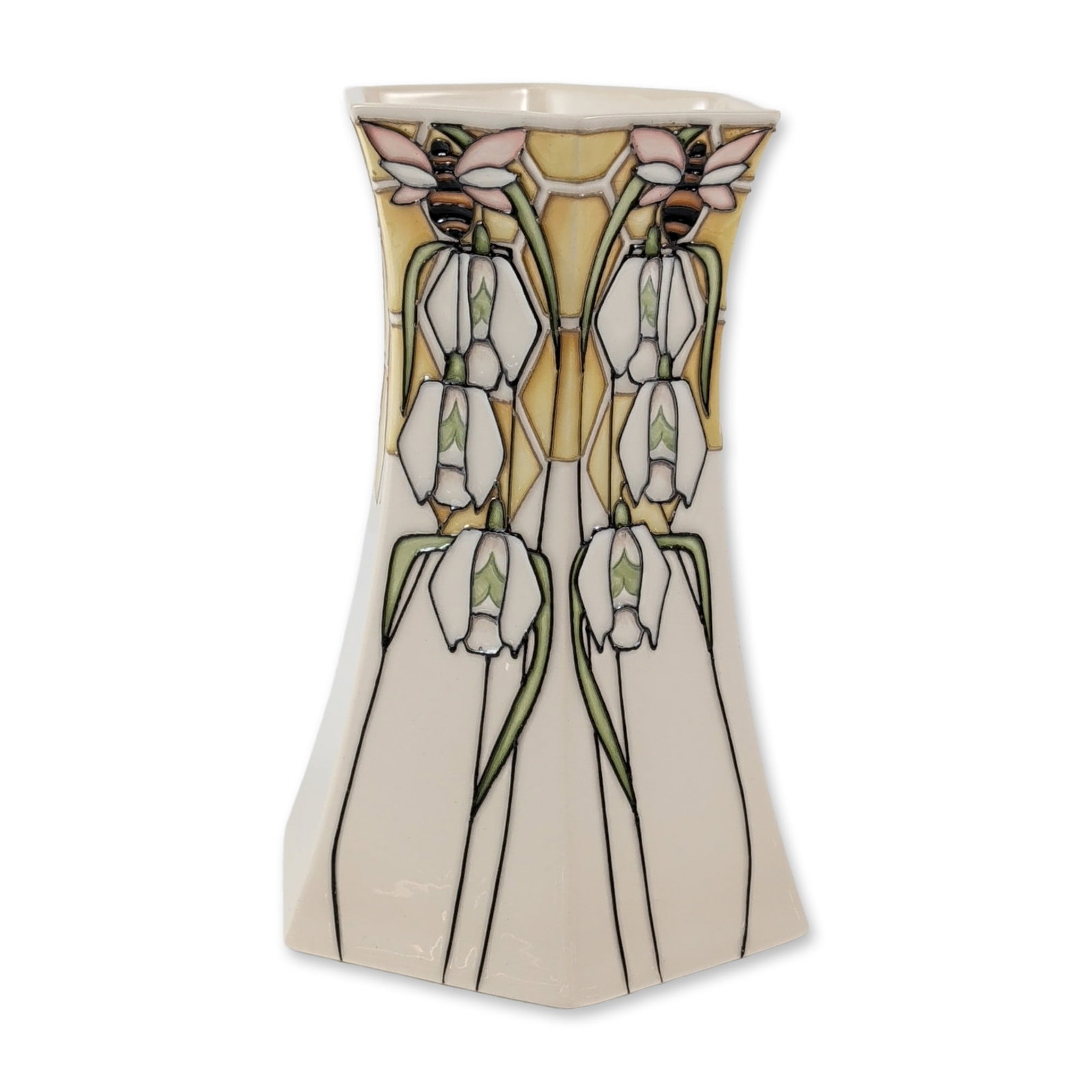 Moorcroft Pottery Scented Snow Hexagonal Vase: Moorcroft Pottery from Stoke-on-Trent, England presents a hexagonal earthenware vase in the Scented Snow pattern, designed by Vicki Lovatt for the Snowdrop Sensations Collection. Its flared shape show