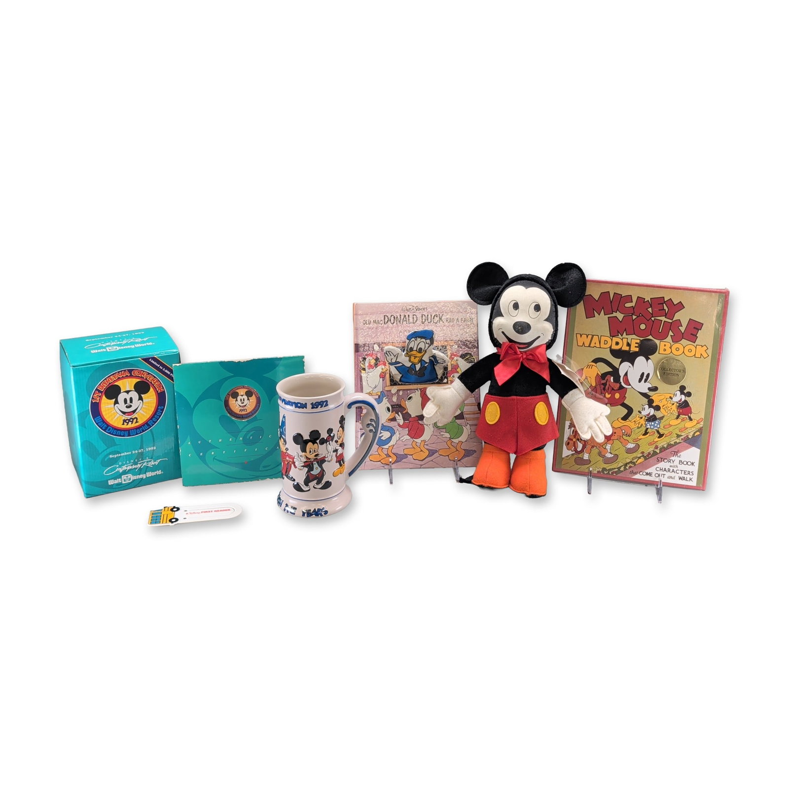 Group of Six 1992 Disneyland Convention Collectibles and Books: Group of Walt Disney World 1st Disneyland Convention memorabilia and vintage books. The collection features a fabric Mickey Mouse plush manufactured by Gund, produced for the 1992 convention. The plus