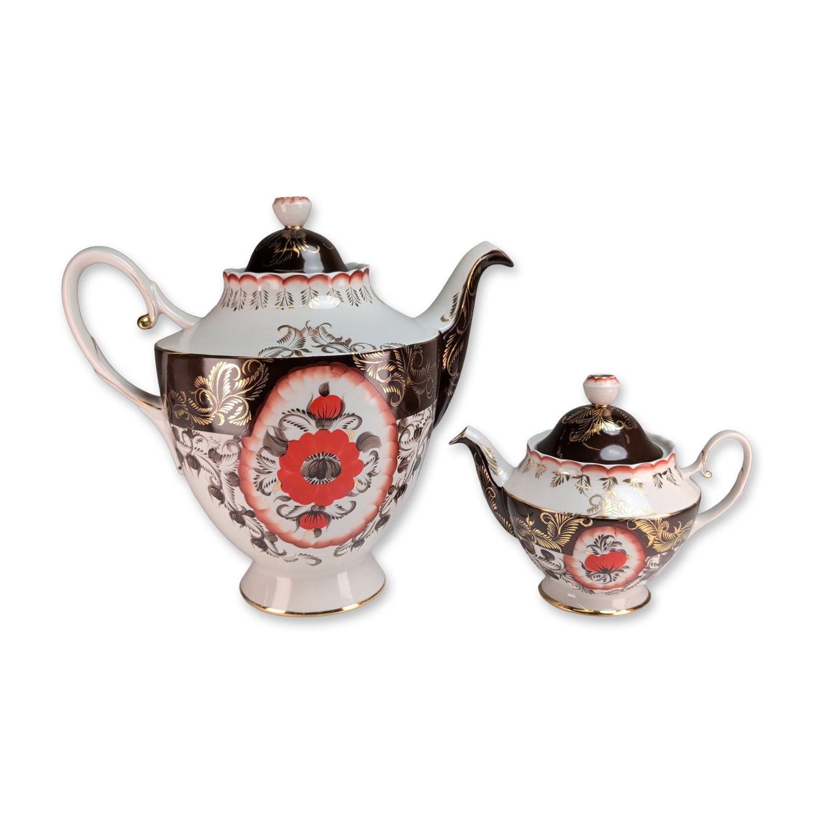 2pc Korosten Factory Ukraine Porcelain Lidded Teapots: Korosten Porcelain Factory, Ukraine, pair of teapots in white porcelain, featuring hand-painted red and black floral motifs set within circular white reserves. The surrounding bodies are decorated in