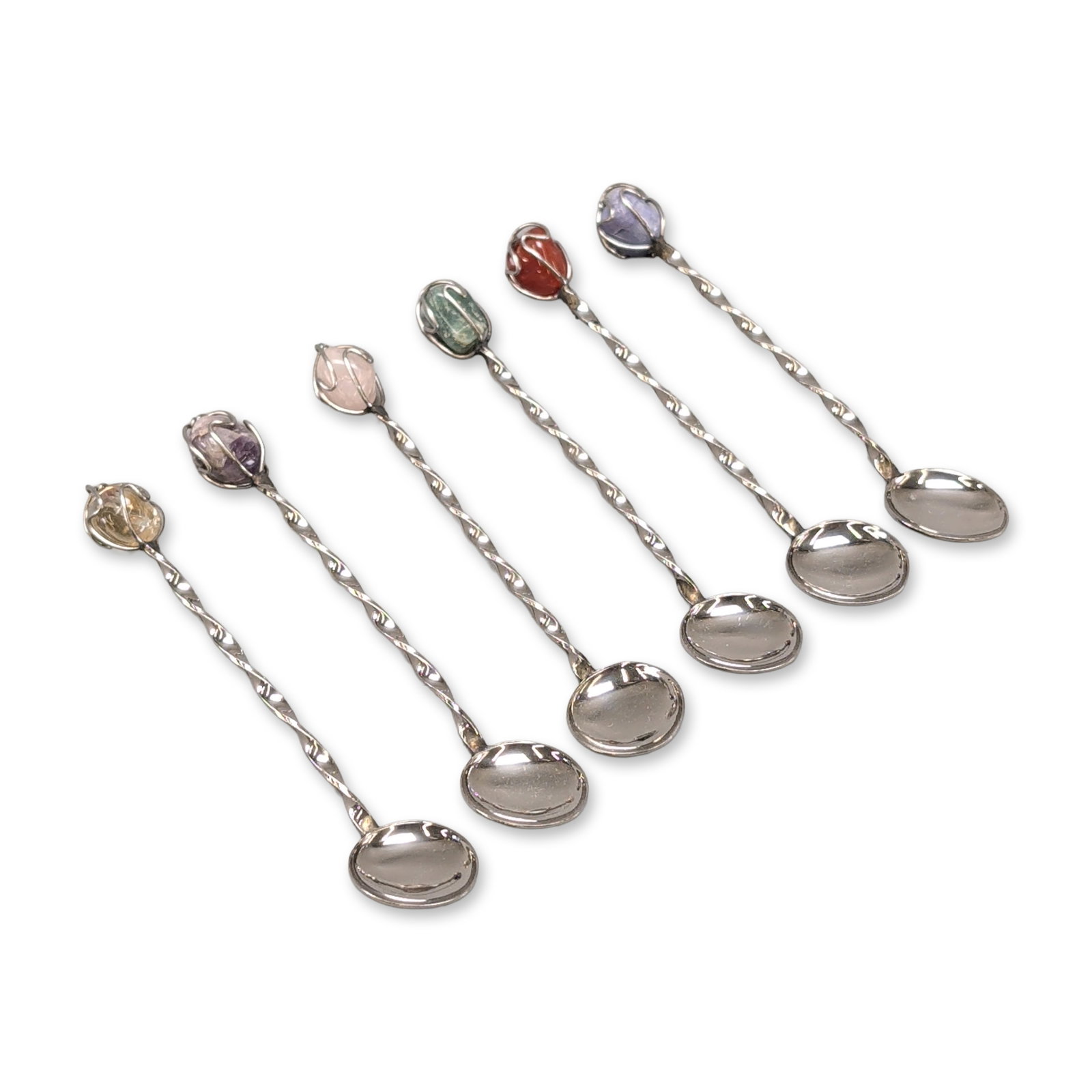 6pc Gemstone Tipped Silver-Tone Spoons: Set of six artisanal small spoons in silver-tone metal. Each piece features a twisted handle terminating in a wire-wrapped cage setting. The finials are mounted with various tumbled semi-precious