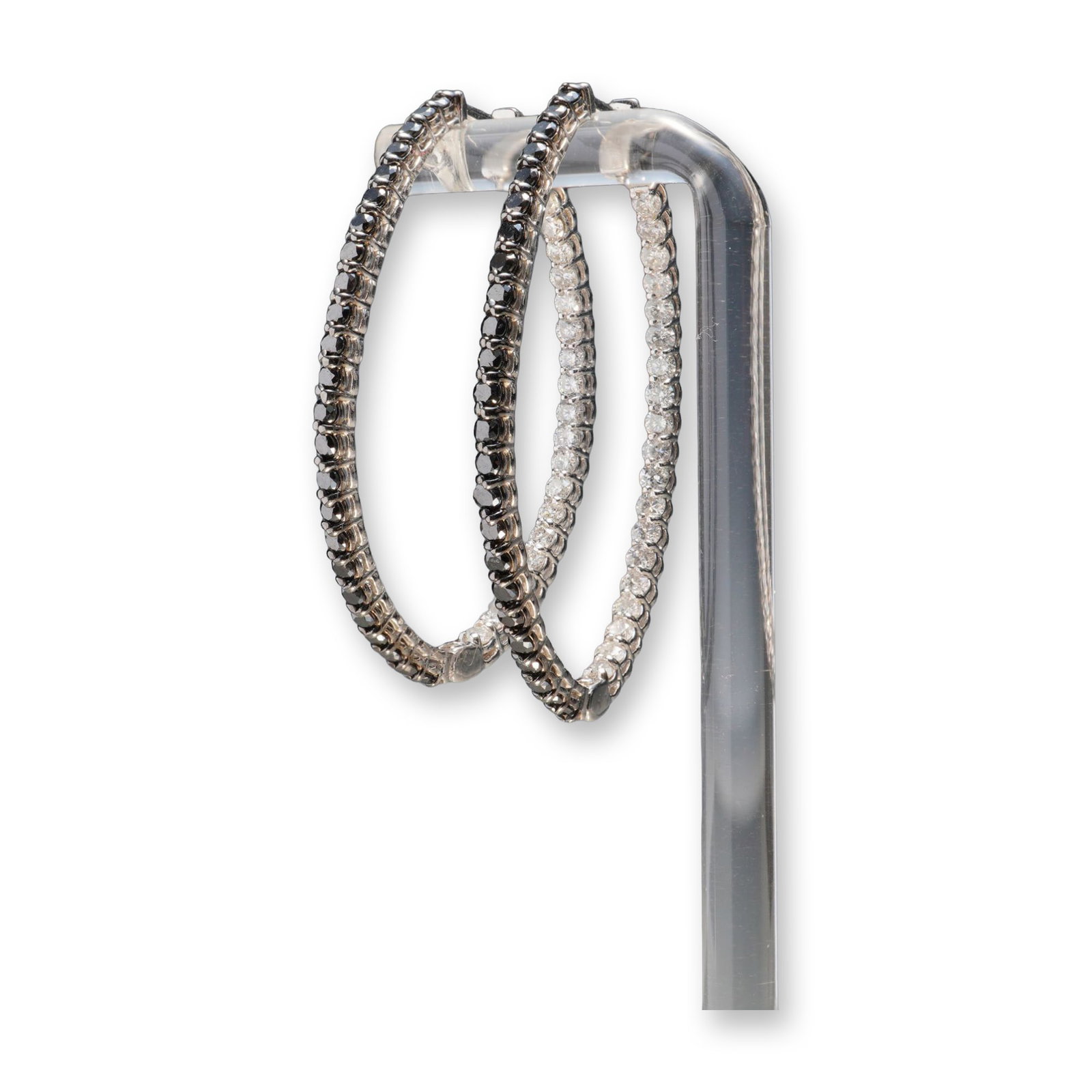 Pair of 14K White Gold 2.77ctw Black & White Diamond Oval Hoop Earrings: A striking pair of 14K white gold oval hoop earrings set with a total of 2.77 carats of round black and white diamonds. The distinctive design features contrasting stones, with black diamonds adorning
