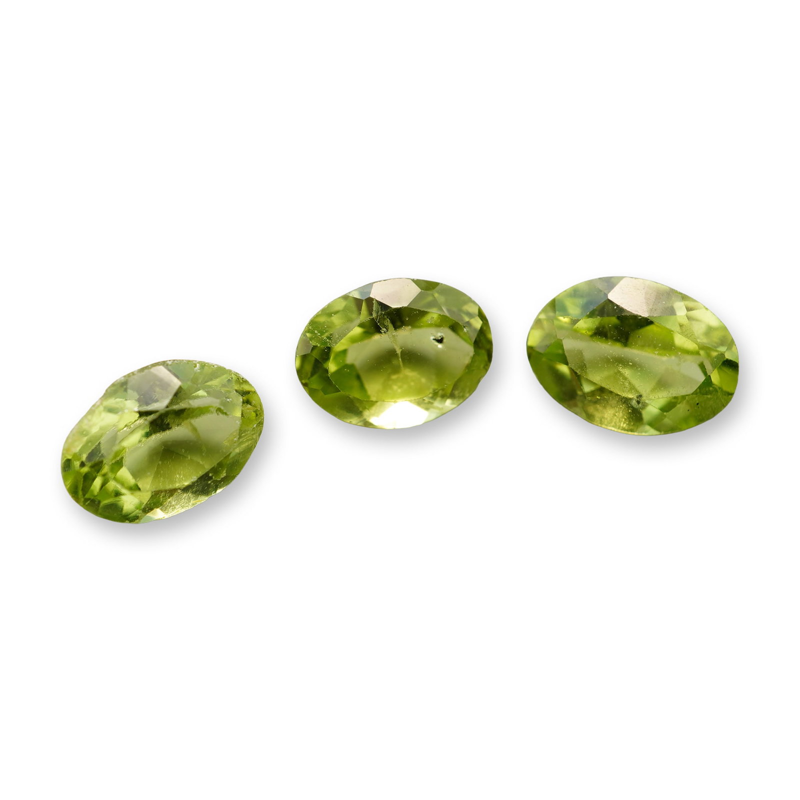 3pc Oval Peridot Gemstones: Beautiful grouping of 3 Peridot stones 0.91-0.96ctw. A green round peridot is a vibrant, August birthstone renowned for its unique single-color profile-ranging from bright lime to deep olive
