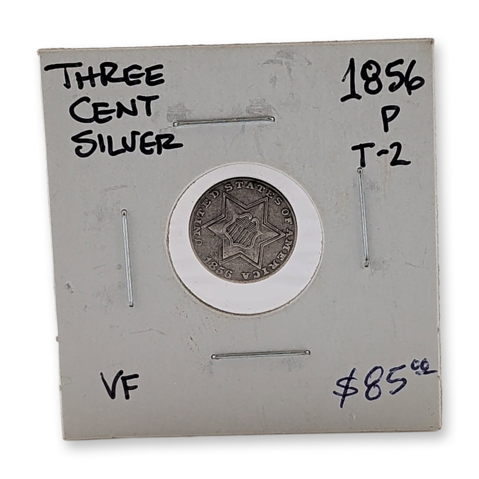1856 US Three Cent Trime Silver Type 2 Coin: US 1856 Three Cent Silver coin, also known as a trime, Type 2 variety. Composed of 90% silver, the obverse features a six-pointed star with a two-line border and central shield, bearing the incised le