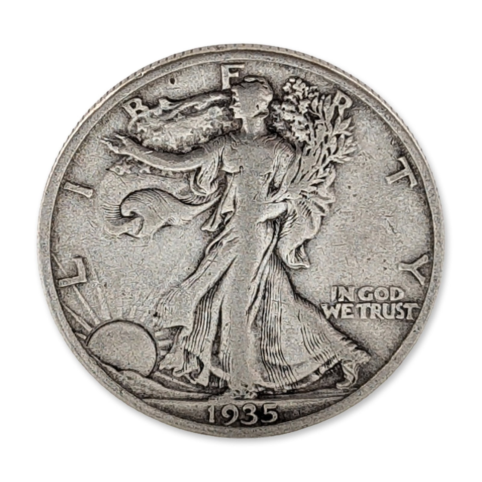 1935-S US Walking Liberty Silver Half Dollar Coin: US 1935 Walking Liberty half dollar in 90 percent silver. The obverse is inscribed L I B E R T Y, IN GOD WE TRUST, and dated 1935. The reverse features a small, impressed S mint mark below the pine br