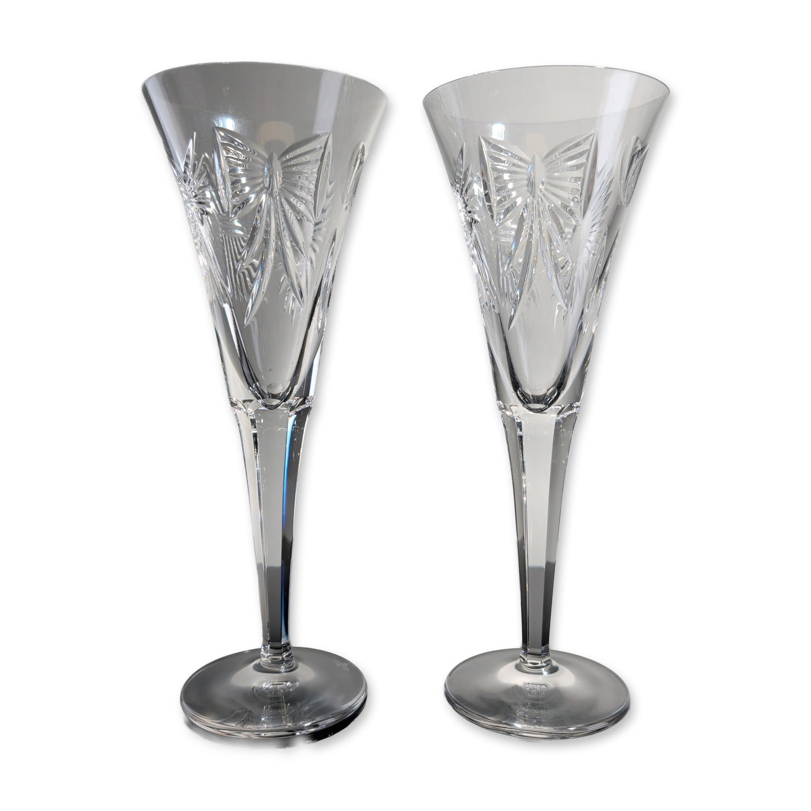 2pc Waterford Millennium Happiness Crystal Champagne Flutes: Waterford pair of champagne toasting flutes in lead crystal, part of the Millennium series in the Happiness pattern. Each piece features a trumpet-shaped bowl decorated with a central sunburst motif a