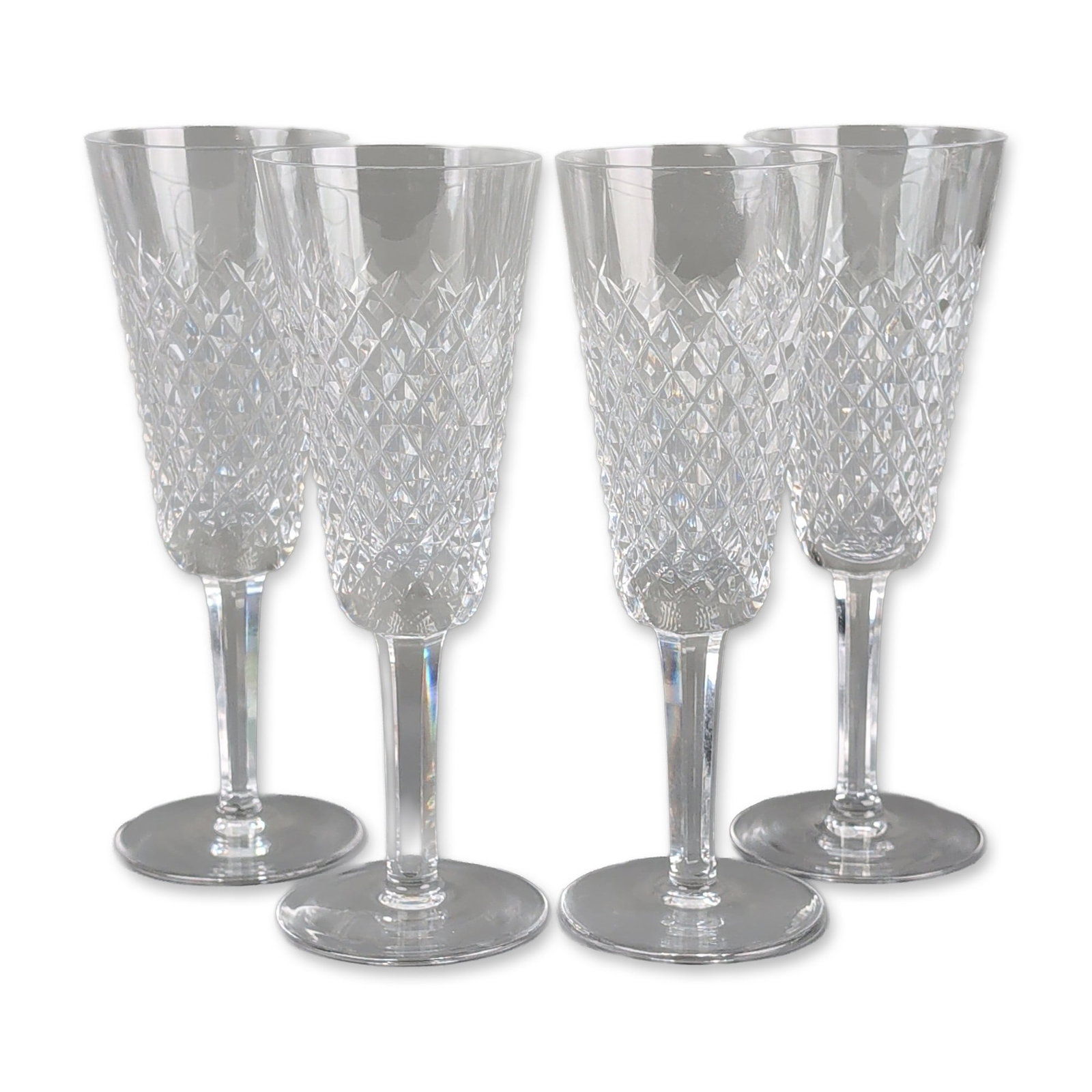 4pc Waterford Alana Crystal Champagne Flutes: Waterford. Group of champagne flutes in Alana cut crystal, featuring a flared bowl decorated with a lower register of diamond-cut cross-hatching beneath vertical flute cuts, supported by multi-faceted