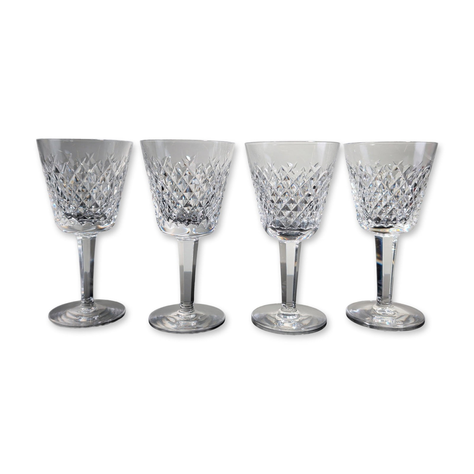 4pc Waterford Crystal Alana Wine Glasses: Set of four Waterford lead crystal wine glasses in the Alana pattern, featuring a bowl decorated with a band of diamond crosshatch cuts above vertical wedge cuts. Each piece is constructed with a mult