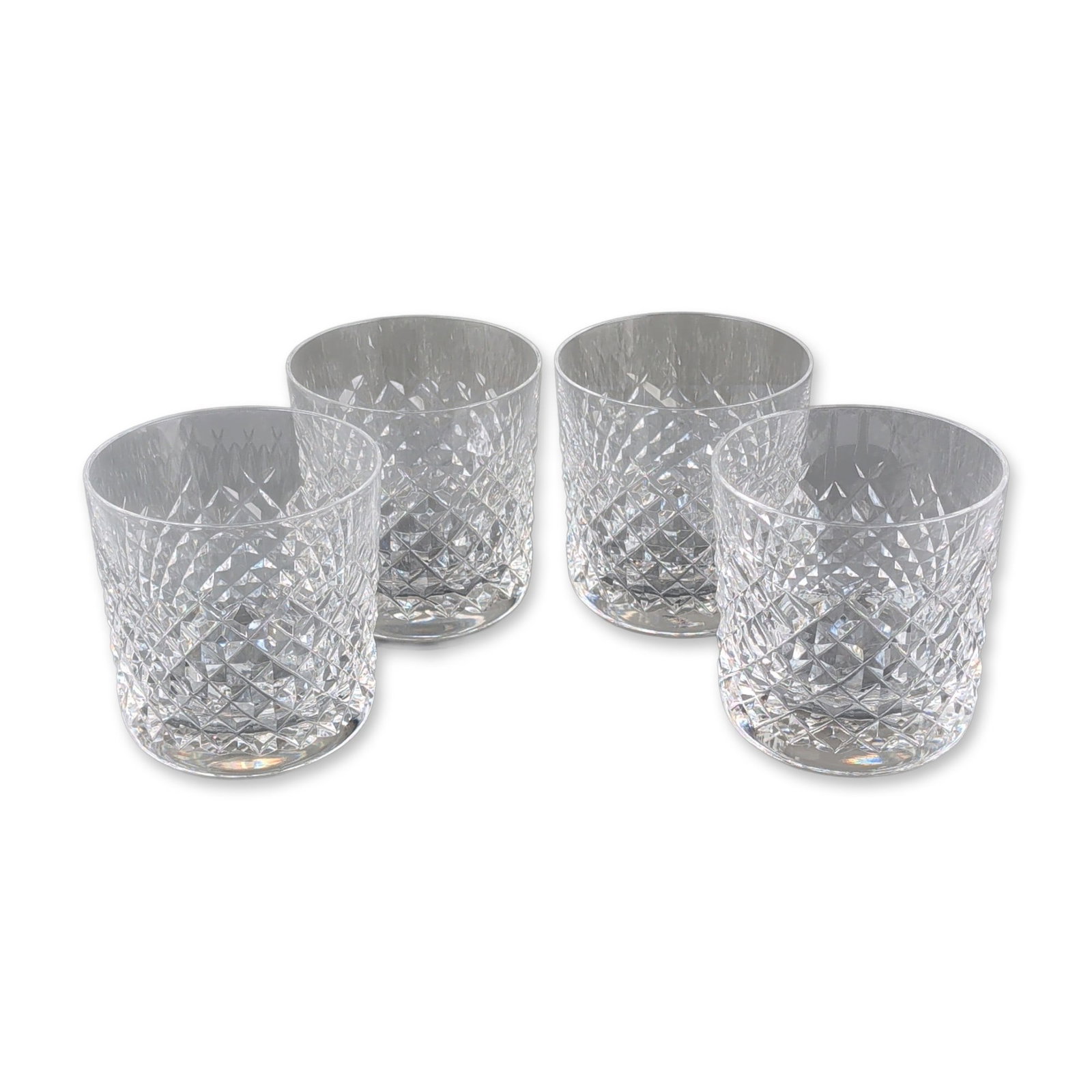 4pc Waterford Cut Lead Crystal Old Fashioned Tumblers, Alana Pattern: Set of four lead crystal old fashioned tumblers, each featuring a cylindrical body with a weighted base. The exterior decoration consists of a deep-cut diamond pattern on the lower half, with a polish