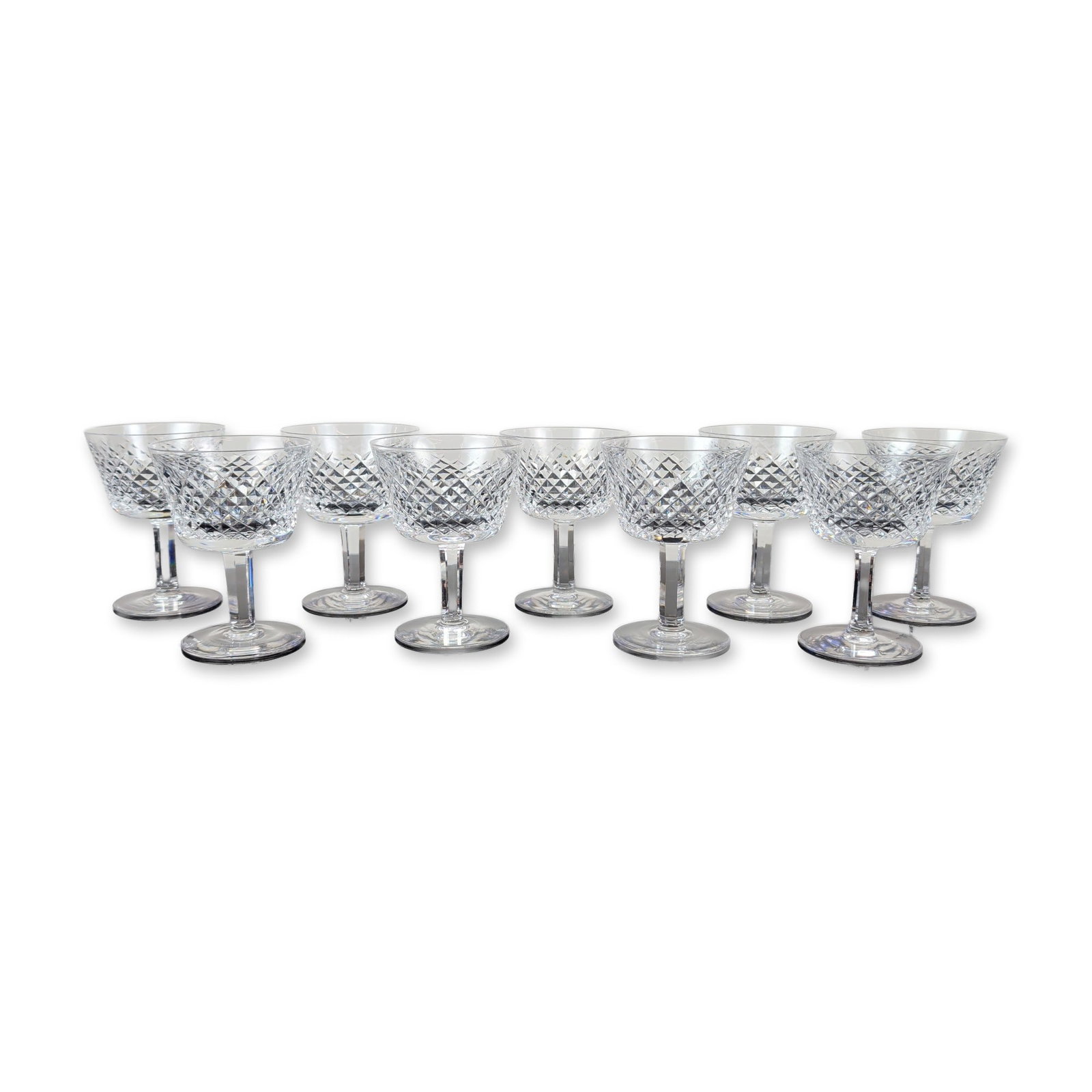 9pc Waterford Alana Crystal Cocktail Glasses: Waterford crystal cocktail glasses in the Alana pattern. Lead crystal construction featuring a deep-cut diamond motif on the bowl, a clear upper rim, a hexagonal faceted stem, and a flat circular base