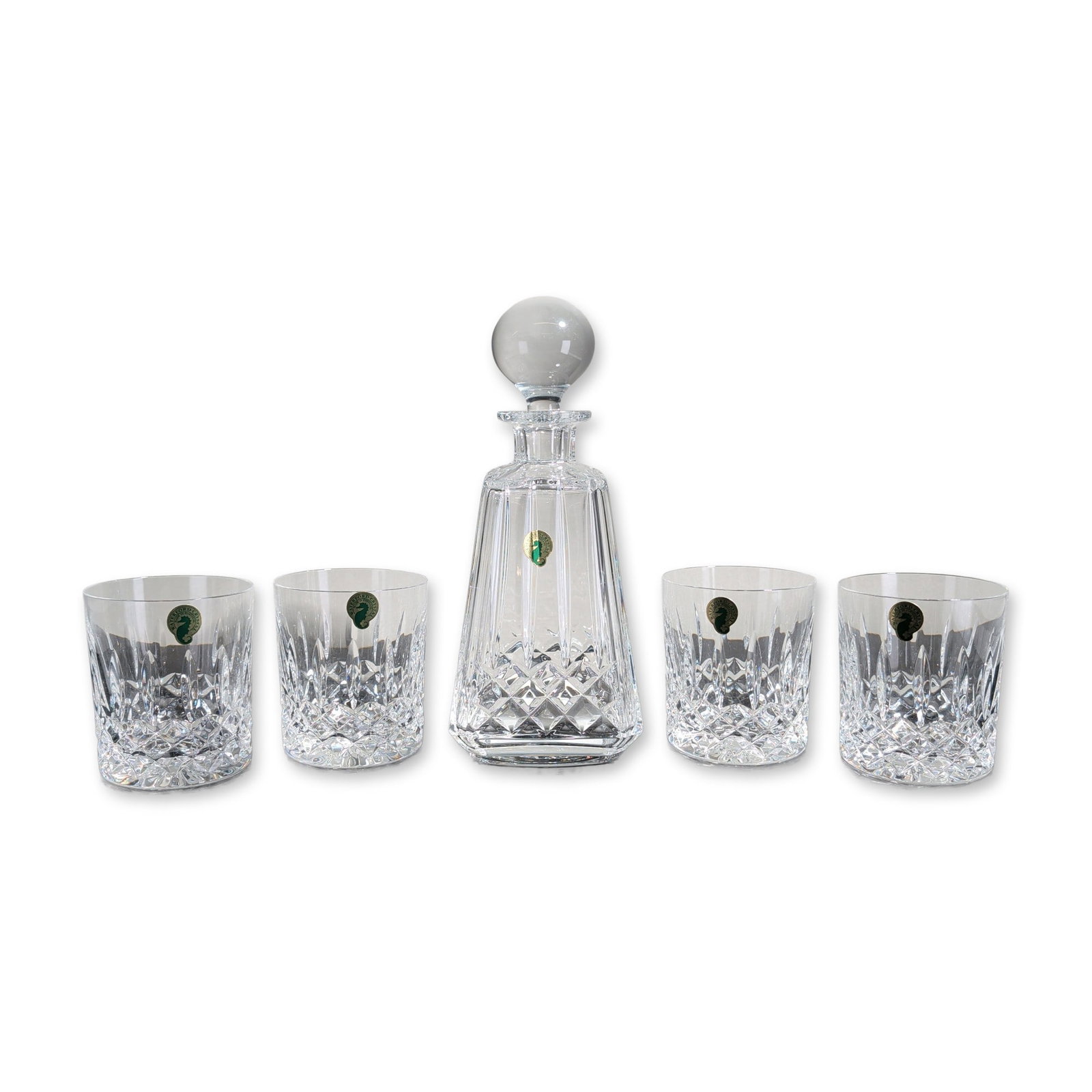 5pc Waterford Lissadel Lead Crystal Decanter Set: Waterford lead crystal spirit set in the Lissadel pattern. Five-piece set consisting of a square-bodied decanter with a solid spherical stopper and four matching tumblers, featuring diamond-cut cross-