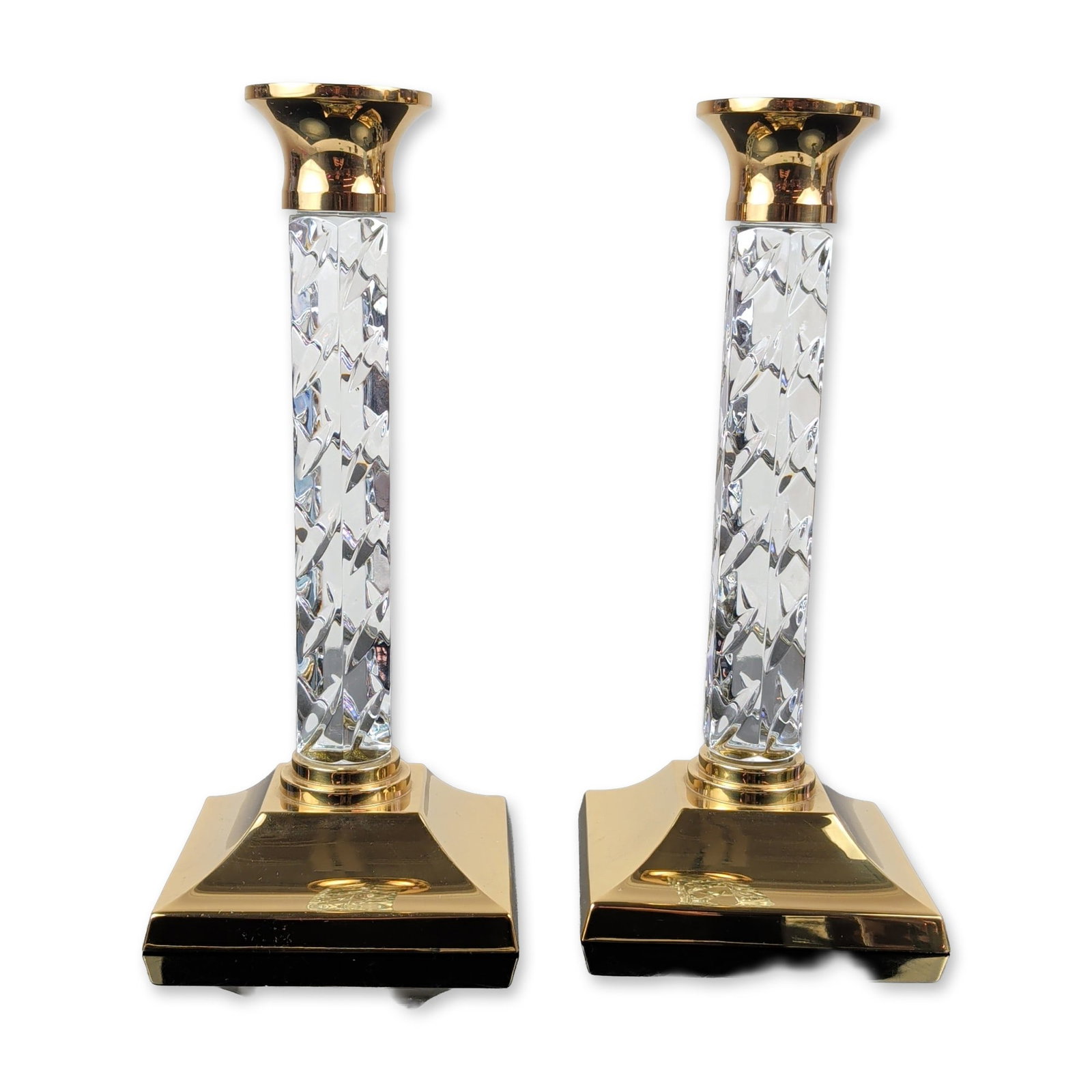 Pair of Waterford Cambridge Crystal and Brass Candlesticks: Waterford Crystal pair of Cambridge pattern candlesticks in lead crystal and polished brass, featuring diamond-cut crystal stems mounted to square stepped pyramidal bases and flared candle cups. An ac