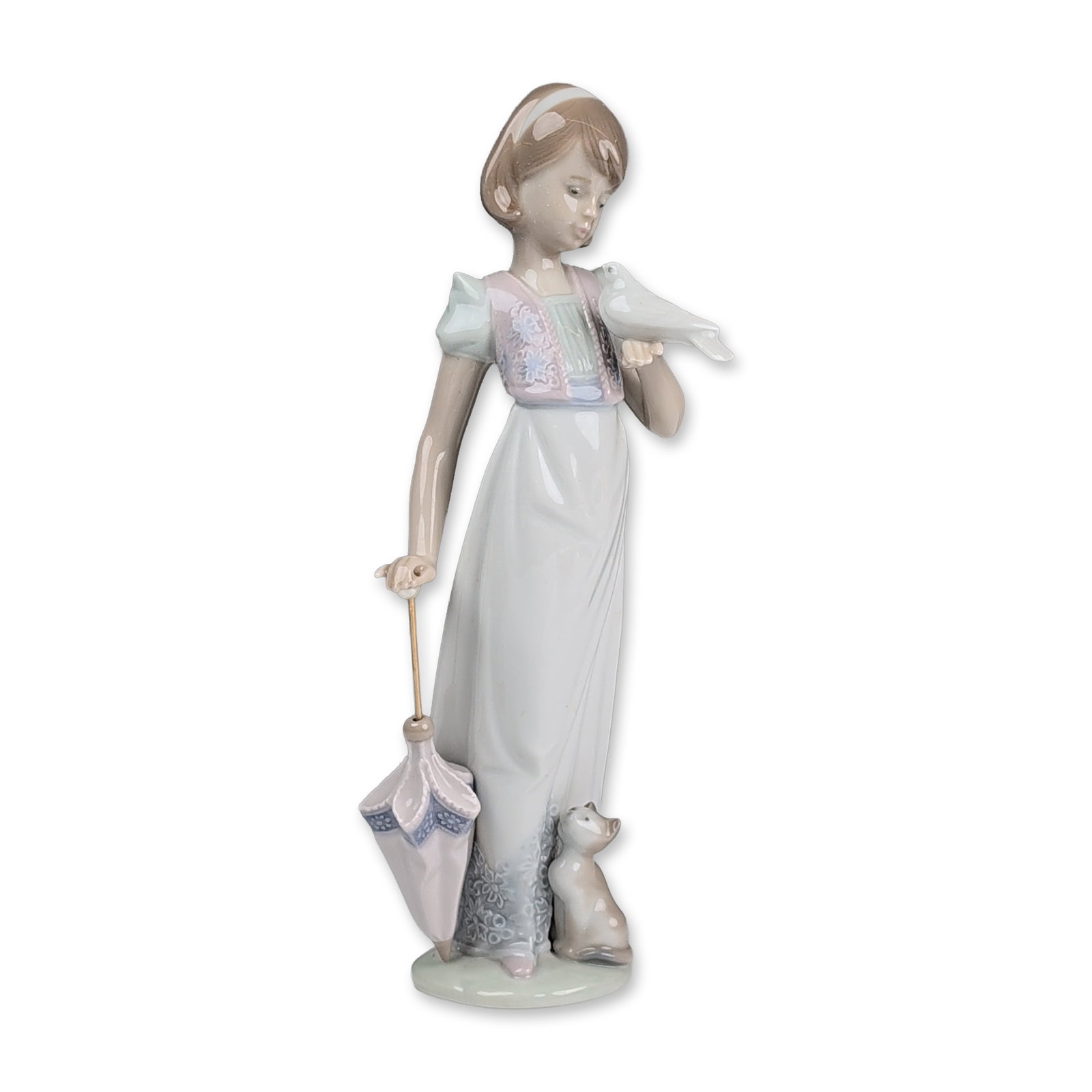 Lladro Porcelain Figurine, Summer Stroll 1007611: Depicting a young woman in a flowing dress with pale blue and pink floral accents and a headscarf. The figure holds a white dove in both hands and a closed parasol with a metal shaft and pearl-like ha