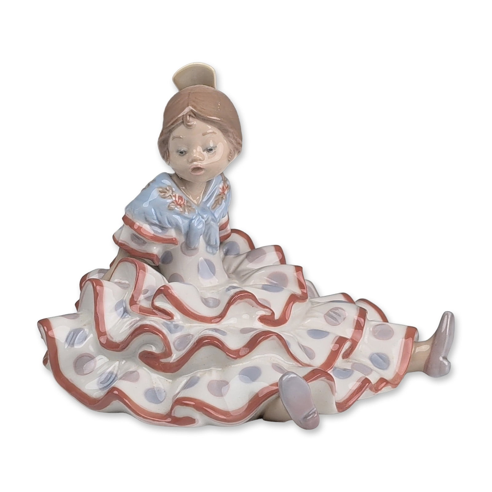 Lladro Spanish Porcelain Figurine, A Time to Rest 01005391: Spanish Lladro glazed porcelain figurine, model number 5391 titled A Time to Rest, depicting a seated young girl in traditional flamenco attire. The figure is modeled wearing a white dress with pale b