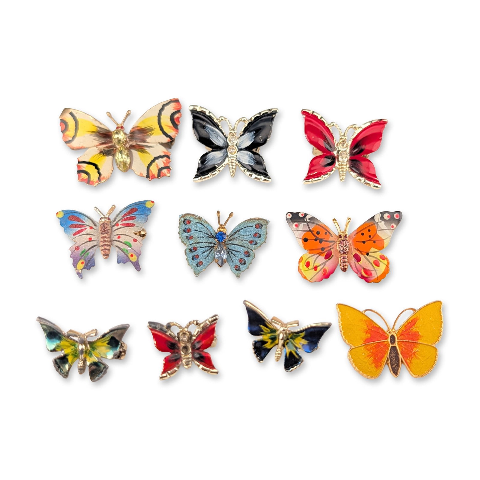 10pc Collection of Butterfly Costume Jewelry Brooches: Collection of ten butterfly-motif costume jewelry brooches, including a Korean example, in gold-tone and silver-tone base metals. The assortment features polychrome enamel and painted wing