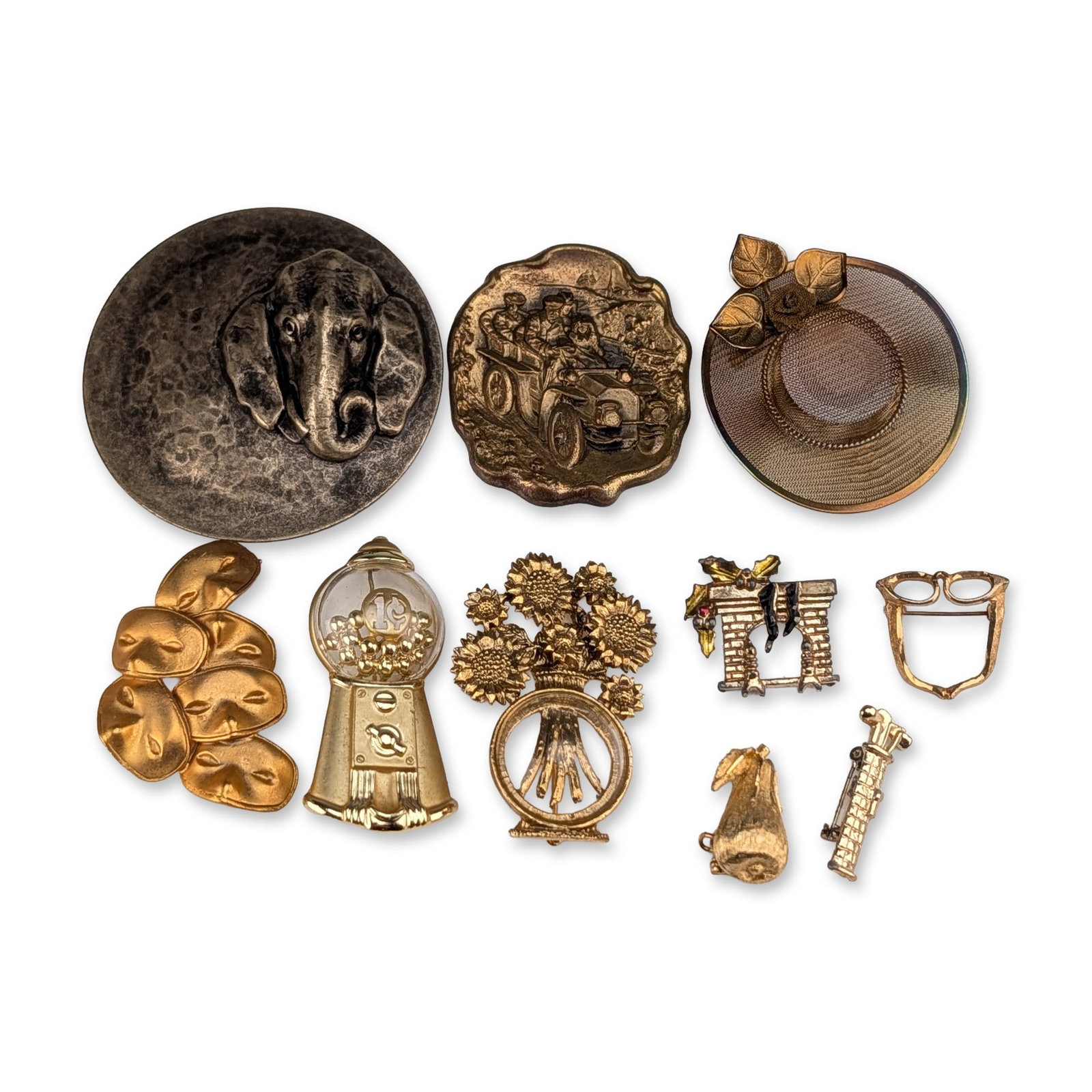 10pc Collection of Vintage Novelty Costume Jewelry Brooches: An assortment of ten vintage figural and novelty costume jewelry brooches in various metallic finishes and materials, mid-20th century. The collection includes a circular pewter-tone elephant head pin