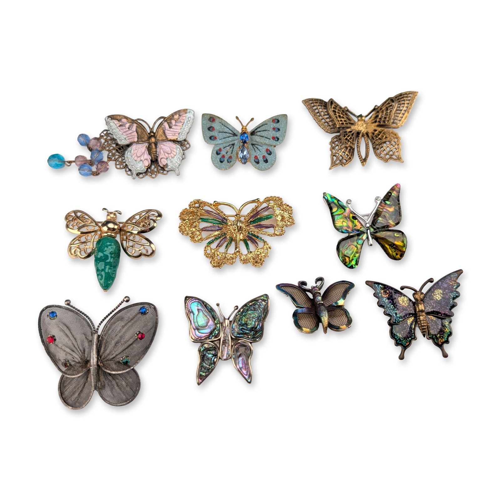 10pc Group of Vintage and Contemporary Butterfly Brooches: Collection of ten vintage and contemporary butterfly and insect themed brooches in various materials and styles. The lot features a silver butterfly brooch with abalone shell inlay, impressed on the r