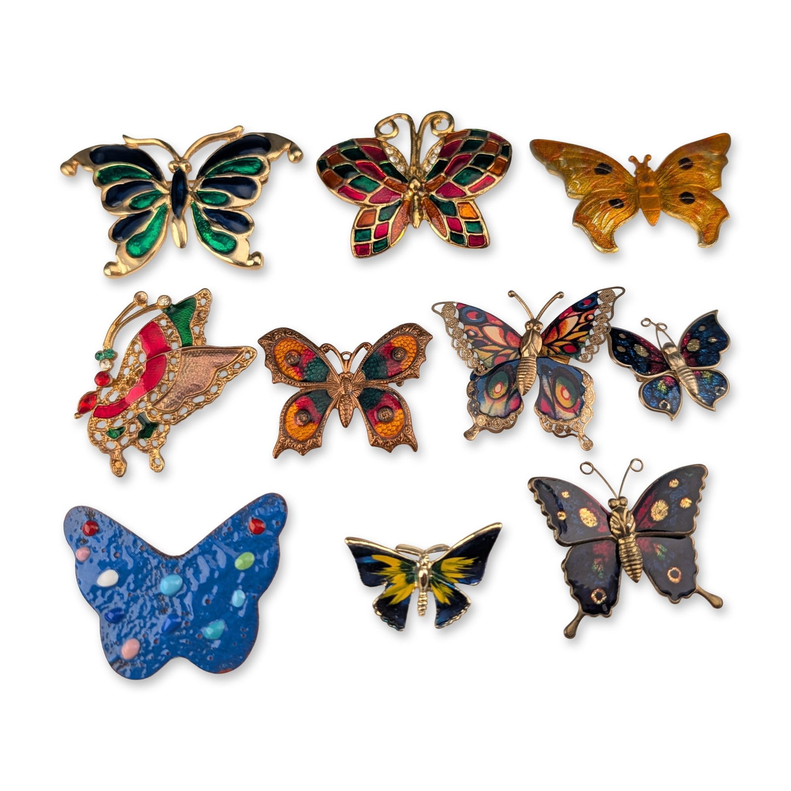 10pc Group of Vintage Enamel Butterfly Brooches: Group of ten vintage butterfly-motif brooches in gold-tone and copper-tone base metals featuring assorted cloisonne-style, painted, and translucent enamel work. One example features yellow and orange 