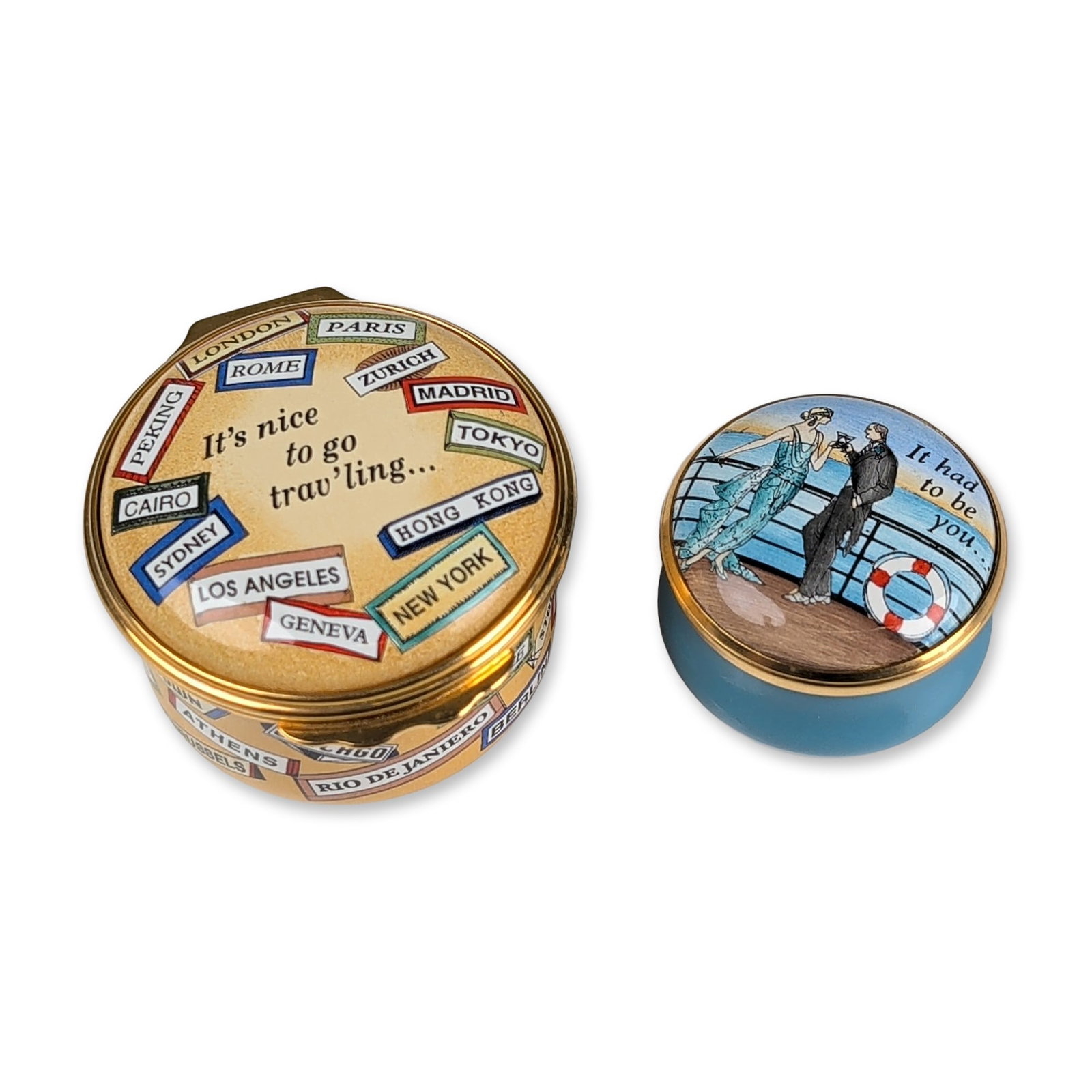 2pc Halcyon Days English Enamel Trinket Boxes: Two Halcyon Days trinket boxes in enamel on copper with gilded metal mounts. The larger box features a yellow ground decorated with international travel labels in luggage-tag styles, a lid inscribed '