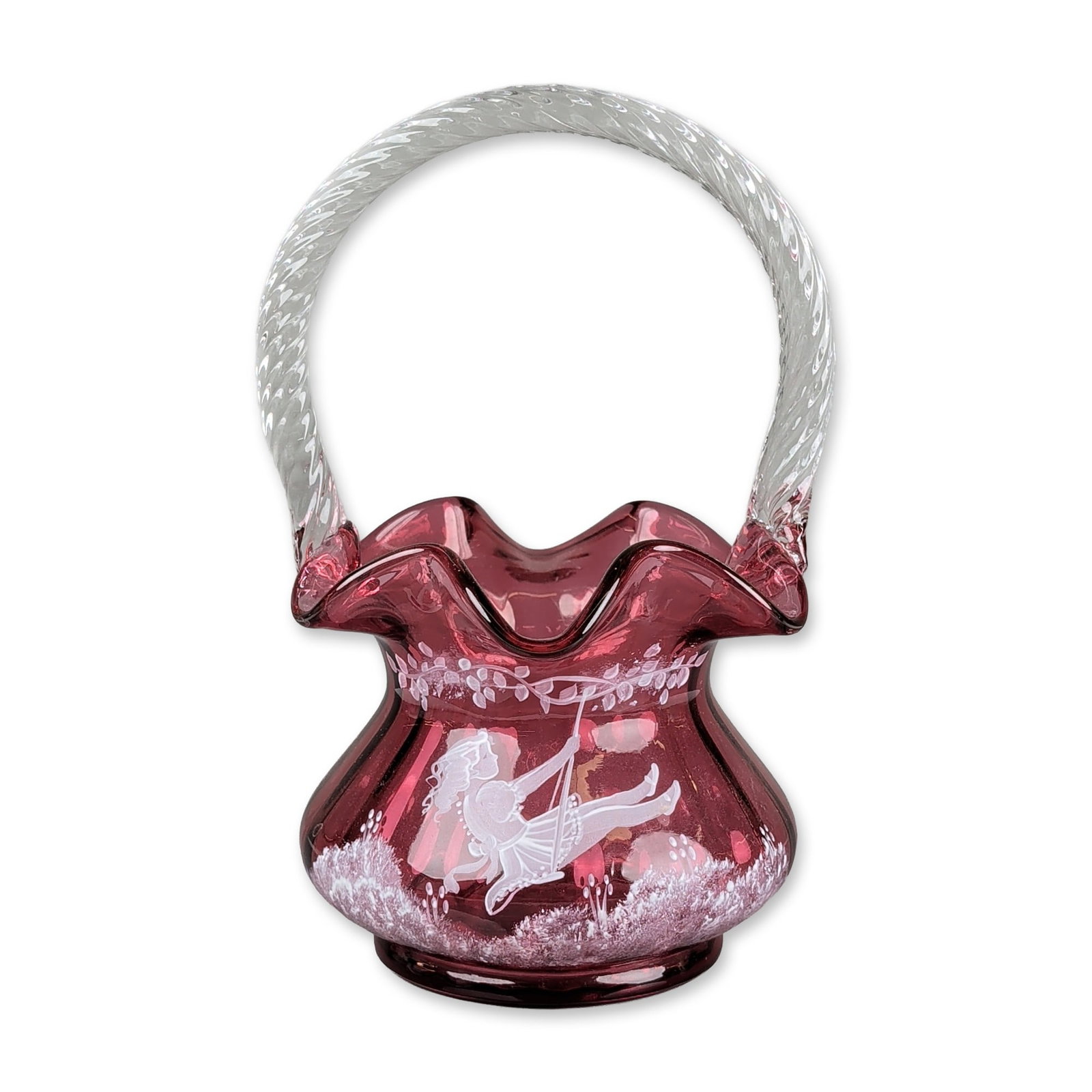 Fenton Limited Edition Hand Painted Glass Basket: Fenton Art Glass basket in ruby red glass featuring a ruffled rim and an applied clear twisted glass handle. The exterior is decorated with hand-painted white enamel in the Mary Gregory style, depicti