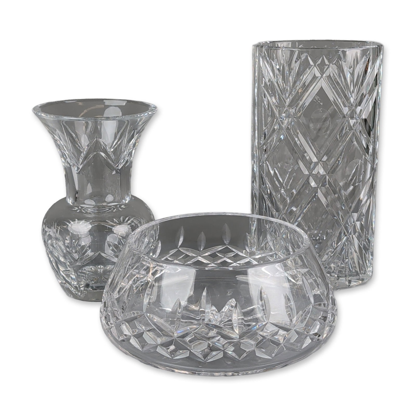 3pc Waterford Cut Crystal Vases and Bowl: Trio of Waterford cut lead crystal vessels. The collection includes a cylindrical flower vase, a flared bud vase with a bulbous base, and a low round bowl. Each piece features the signature pattern of