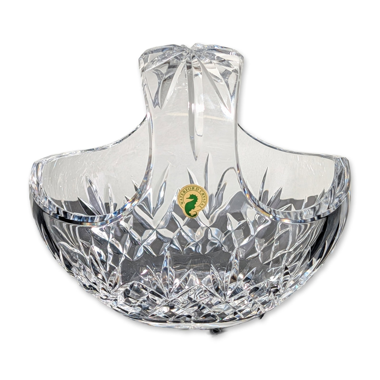 Waterford Crystal Ferndale Handled Basket: Waterford handled basket in lead crystal, featuring the Ferndale pattern with a band of diamond cuts below upright radiating wedge cuts. The underside of the base is decorated with a multi-point starb