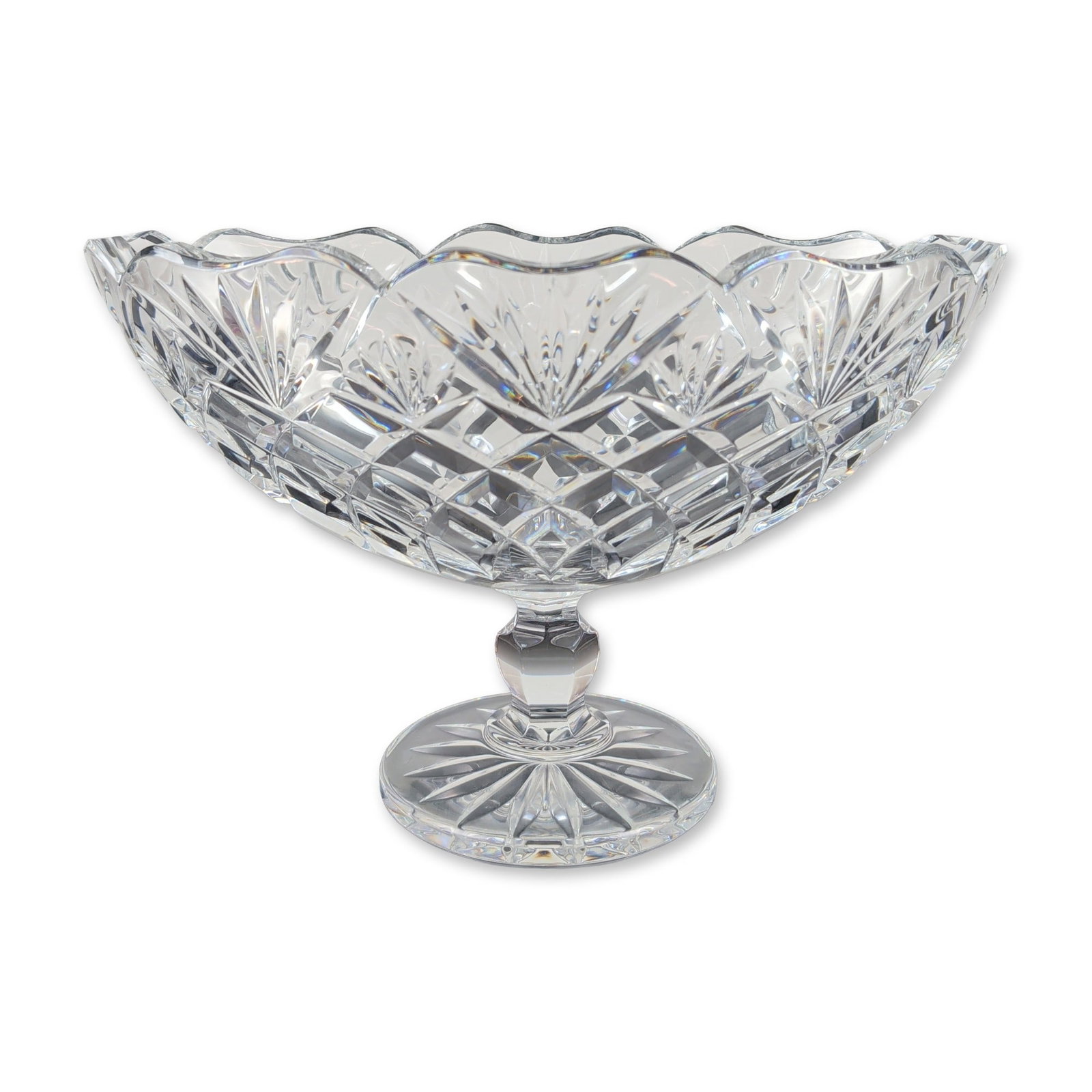 Waterford Irish Lead Crystal Boat Bowl: Irish lead crystal pedestal boat bowl by Waterford. The vessel features a flared body with a scalloped rim, decorated with alternating vertical panels of deep-cut diamond wedge motifs and radiating su