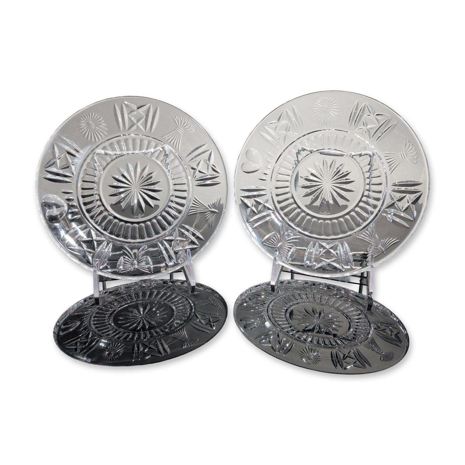 2pc Waterford Millennium Series Crystal Luncheon Plates: Pair of Waterford Millennium Series circular luncheon plates in heavy lead crystal, featuring an intricate multi-motif cutting pattern arranged in twelve panels. The design incorporates recurring moti